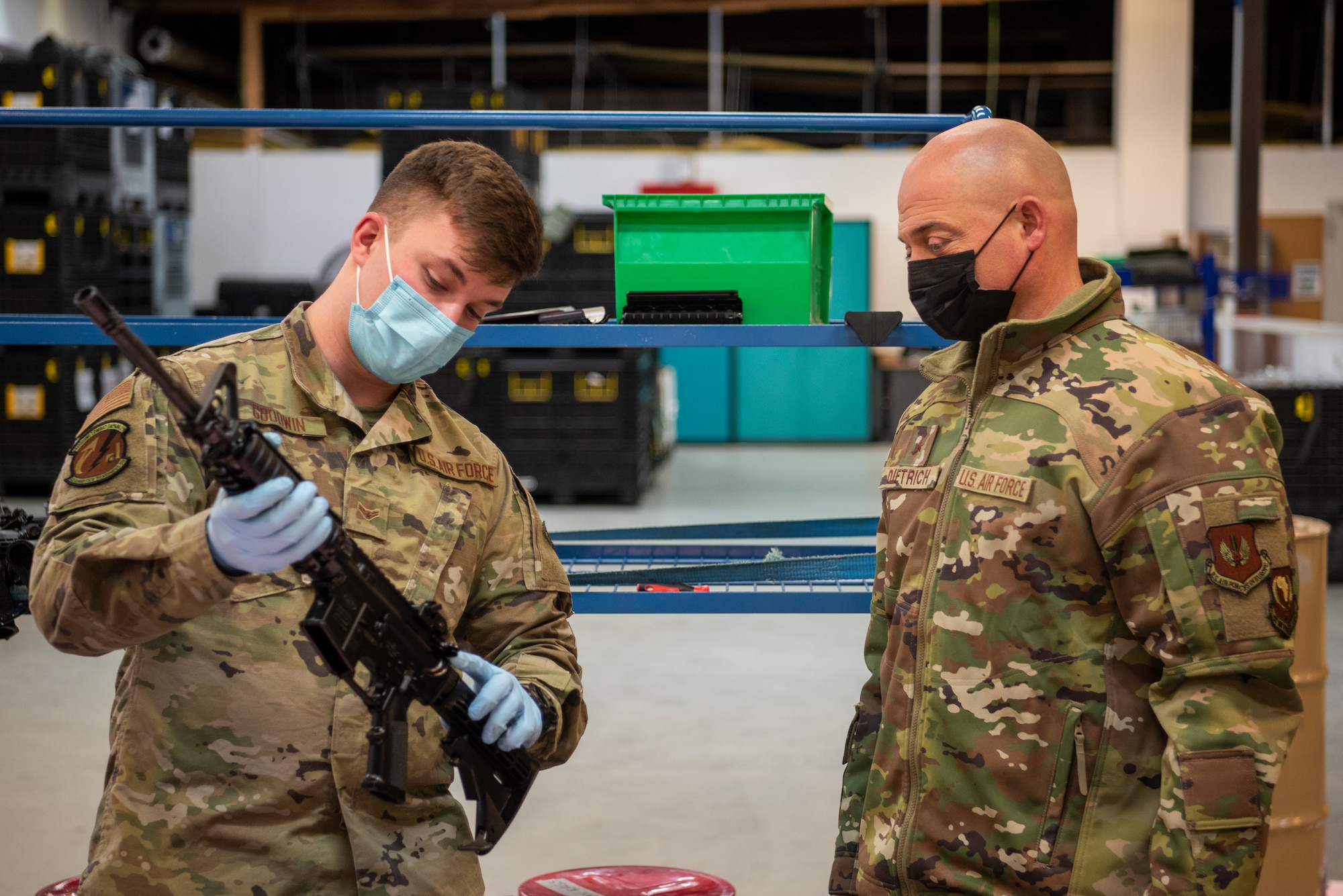 U.S. Air Force Airman 1st Class Gaige Goodwin, 52nd Logistic Readiness Squadron individual protective equipment journeyman, left, shows Brig. Gen. George T. Dietrich III, U.S. Air Forces in Europe - Air Forces Africa director of logistics, engineering and force protection, the most common inspection failure points on the M16 rifle, Jan. 25, 2022, at Spangdahlem Air Base, Germany.