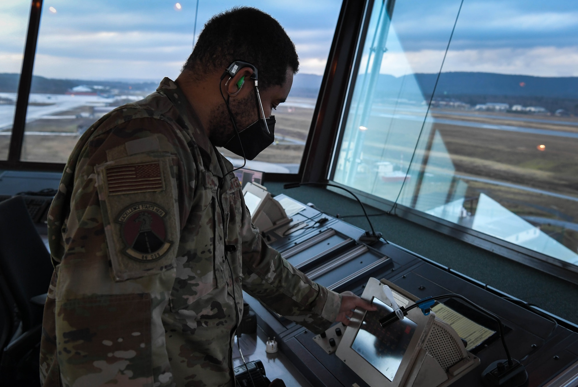 U.S. Air Force Staff Sgt. Vincent Coleman, 86th Operations Support Squadron air traffic control watch supervisor, switches frequencies between aircraft and vehicles to coordinate ground movements on the flightline at Ramstein Air base, Germany, Jan. 20, 2022. Air traffic control Airmen direct aircraft in and out of military airfields, ensuring safe and efficient operations. (U.S. Air Force photo by Airman 1st Class Jared Lovett)