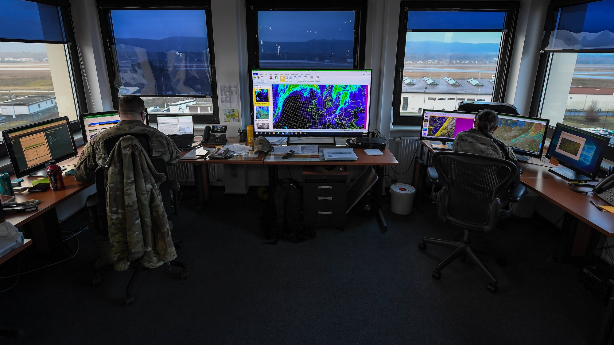 U.S. Air Force Tech. Sgt. Alan-Michael Schroeder, 86th Operations Support Squadron airfield weather operations noncommissioned officer in charge, left, and Capt. Martiza Andicoechea, 86 OSS weather flight commander, analyze the weather forecast at Ramstein Air Base, Germany, Jan. 20, 2022. Weather specialists are constantly collecting information on upcoming weather patterns to ensure the safety of pilots and aircrew. (U.S. Air Force photo by Airman 1st Class Jared Lovett)