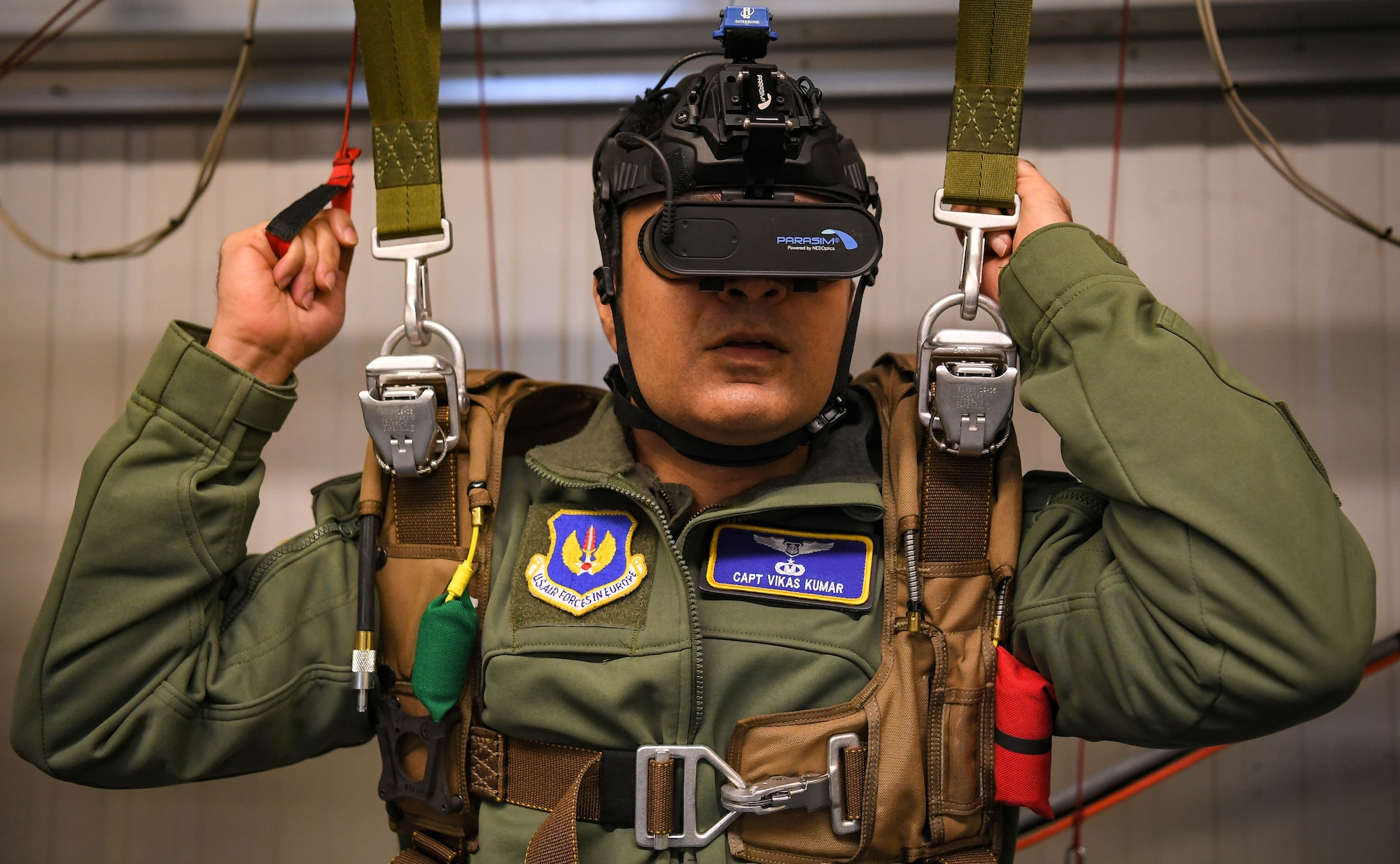 U.S. Air Force Capt. Vikas Kumar, 86th Operations Support Squadron aircrew flight equipment chief wing aerospace physiologist, undergoes the practical portion of an emergency parachute training course at Ramstein Air Base, Germany, Jan. 27, 2022. The parasim is a virtual reality parachute training simulator that allows the trainee to experience an emergency parachute event in a controlled environment. (U.S. Air Force photo by Airman 1st Class Jared Lovett)