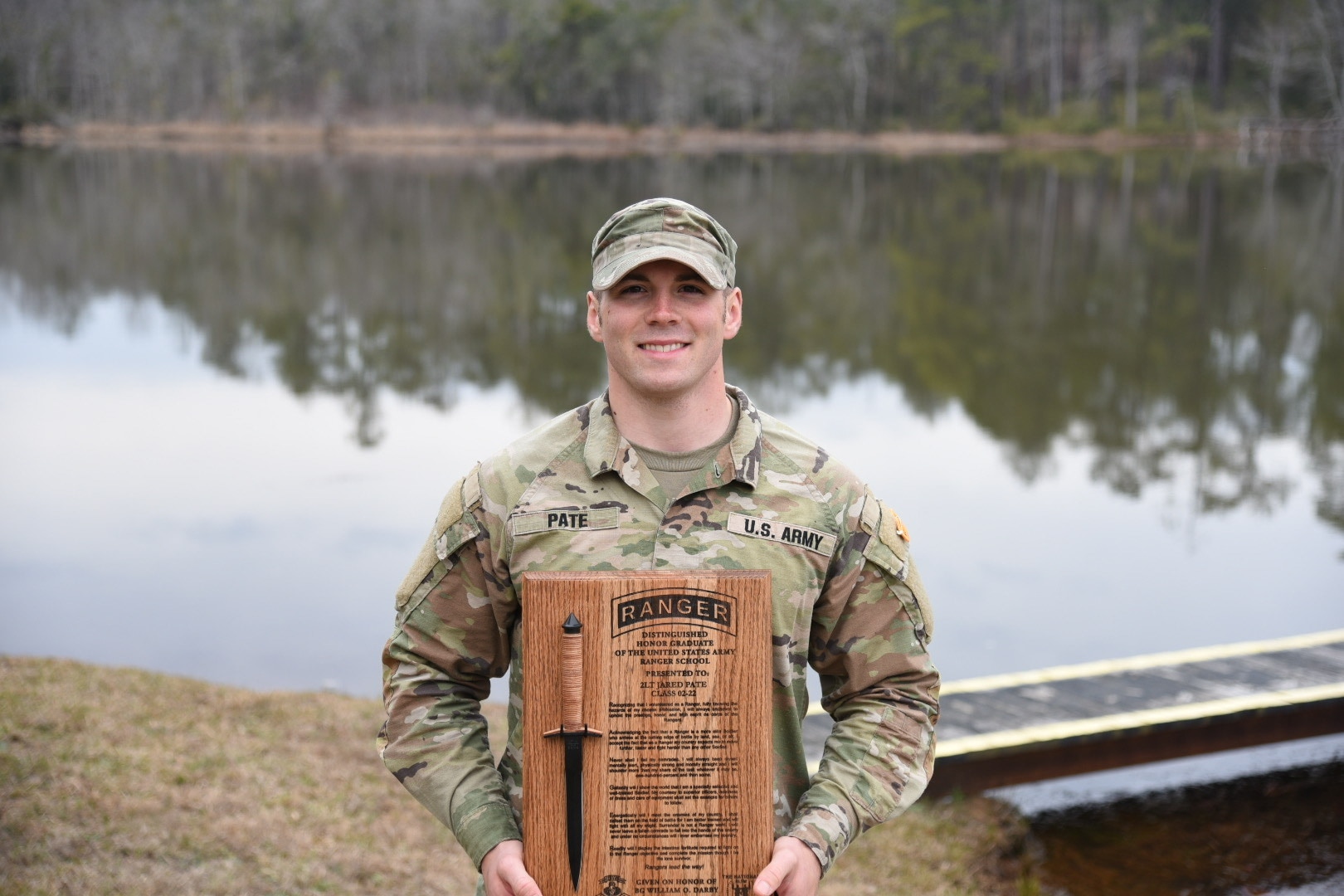 U.S. Army 2nd Lt. Jared Pate, a platoon leader assigned to Charlie Company, 1st Battalion, 121st Infantry Regiment, 48th Infantry Brigade Combat Team, Georgia Army National Guard, poses with a plaque Jan. 28, 2022, at Fort Benning, Georgia. Pate graduated from Ranger School as the distinguished honor graduate of his class.