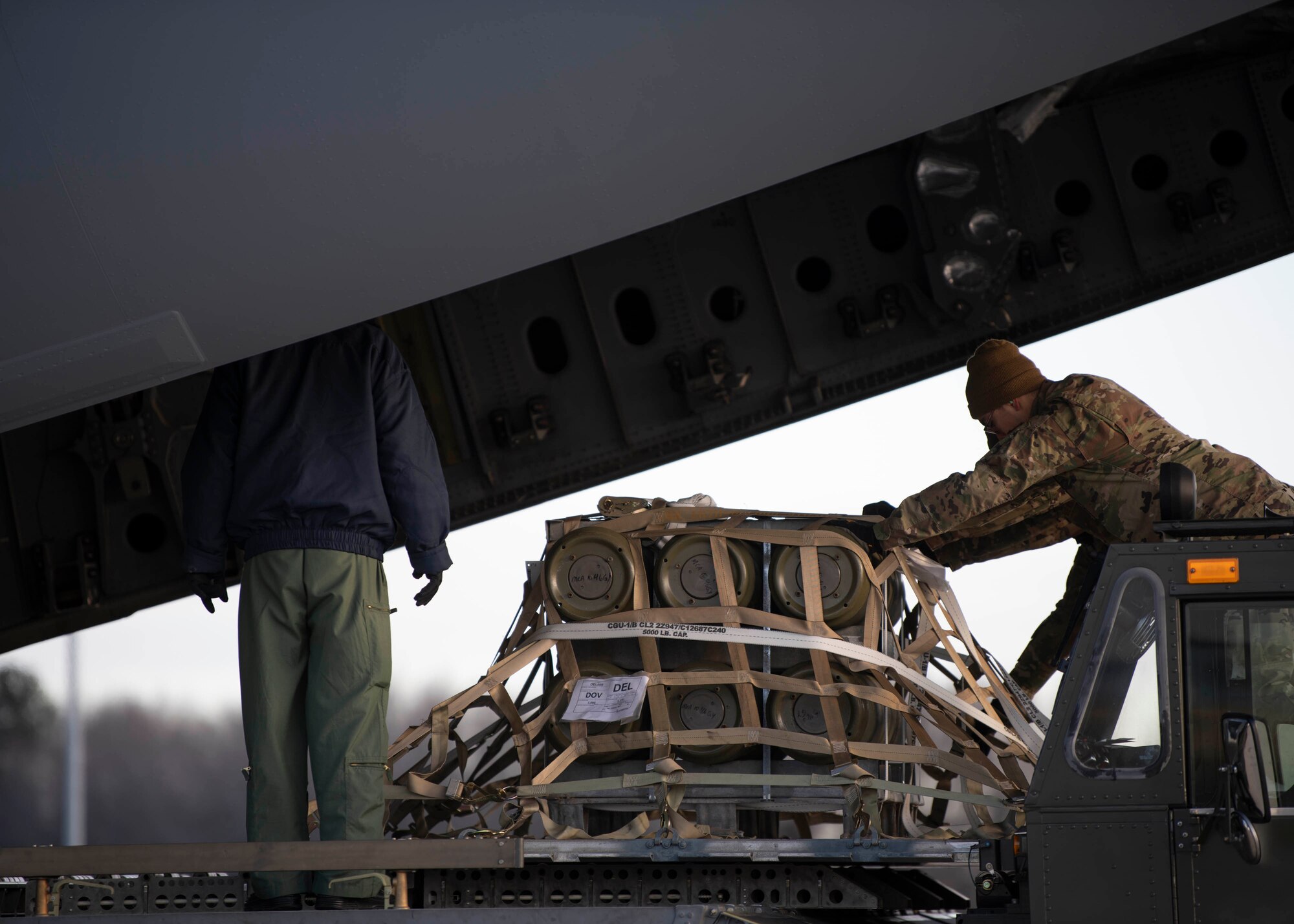 Airmen from the 436th Aerial Port Squadron load cargo bound for India during a foreign military sales mission at Dover Air Force Base, Delaware, Jan. 22, 2022. The United States and India relationship focus is to continue to build a strategic partnership to promote shared interests in the Indo-Pacific region and beyond. (U.S. Air Force photo by Tech. Sgt. J.D. Strong II)