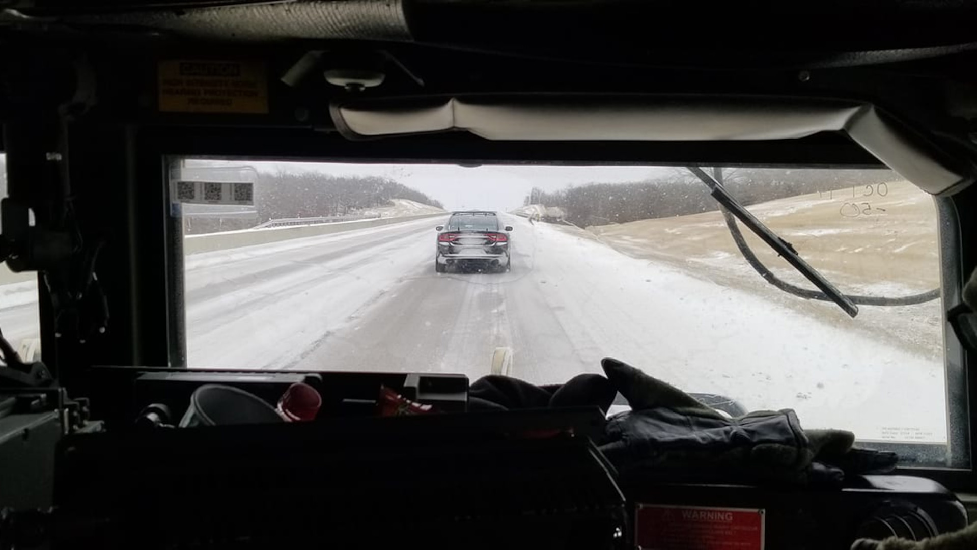 An Oklahoma National Guard humvee follows an Oklahoma Highway Patrol vehicle during a stranded motorist recovery mission along the Turner Turnpike near Stroud, Oklahoma, Feb. 14, 2021. (Oklahoma National Guard photo by Sgt. Anthony Jones)