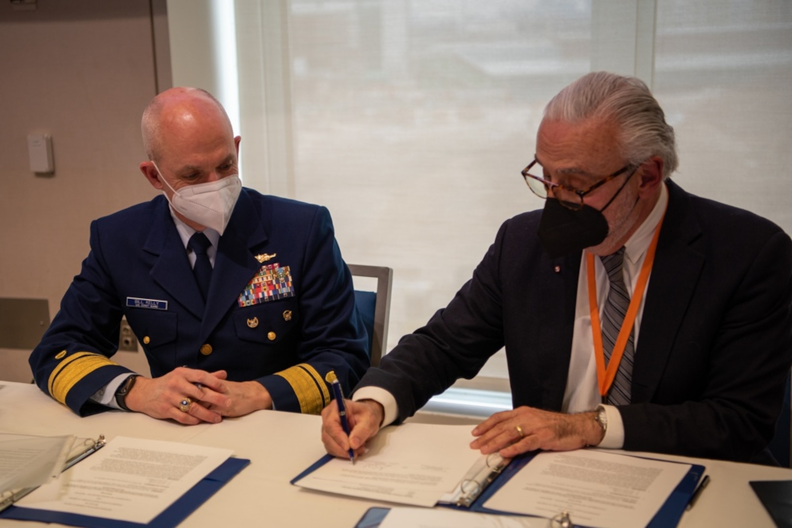 Rear Adm. William Kelly, the U.S. Coast Guard Academy superintendent, signs a memorandum of understanding with University of Massachusetts Chancellor, Marcelo Orozco, as part of the U.S. Coast Guard Academy’s Scholars Pilot program in Boston, January 28, 2022. The scholars program is intended to help students with a desire to join the Coast Guard choose an education path that will benefit them the most during their academic and military careers.(U.S. Coast Guard photo by Petty Officer 3rd Class Briana Carter)