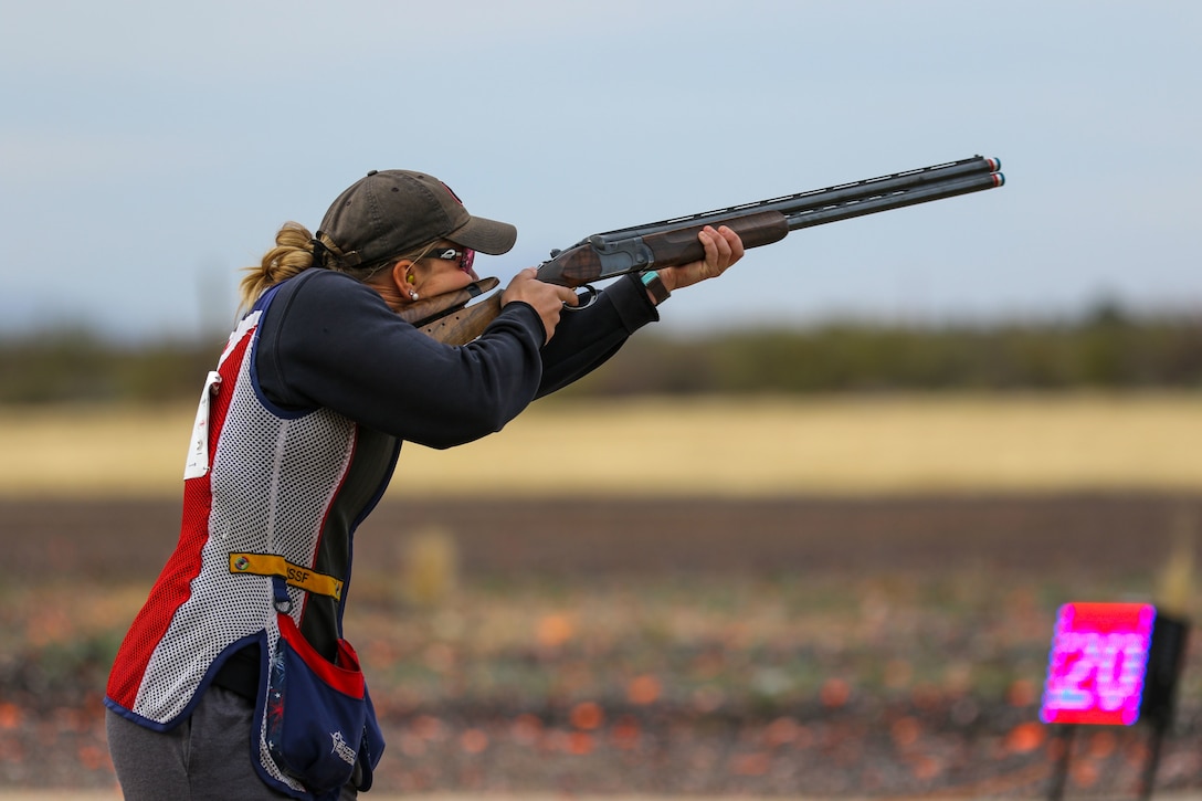 A woman competes at skeet shooting.