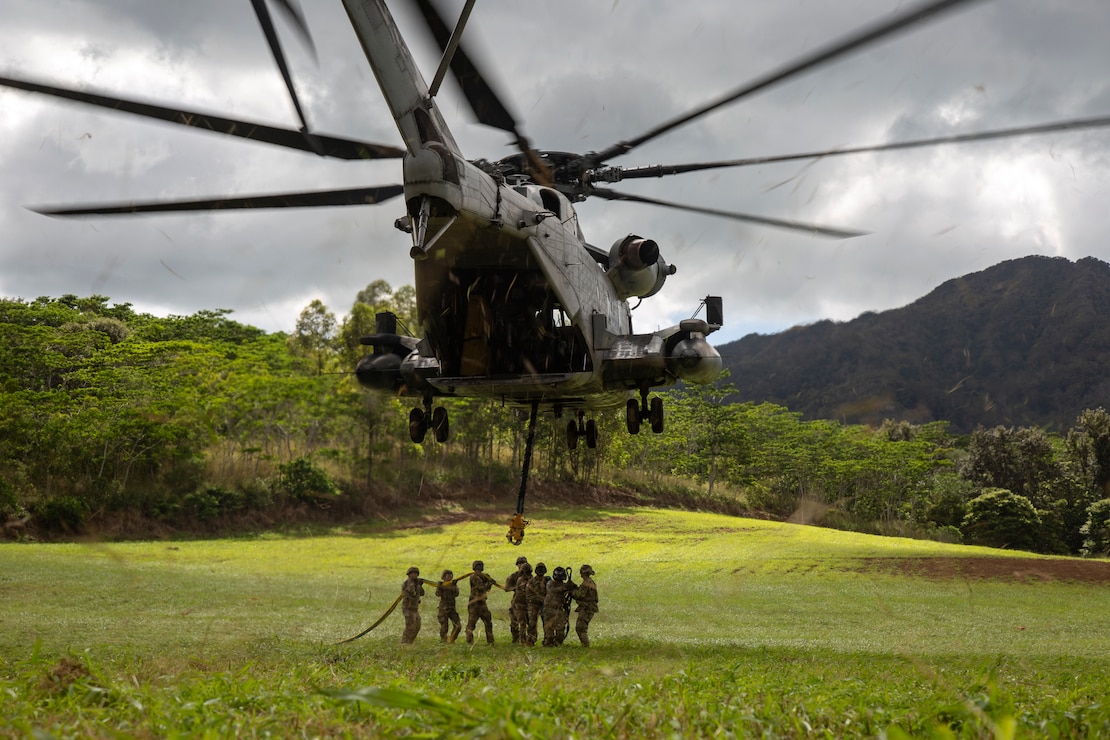 A U.S. Marine CH-53E Super Stallion helicopter assigned to Marine Heavy Helicopter Squadron 463, performs a slingload of an Army H-60 helicopter at U.S. Army Schofield Barracks, Hawaii, Jan. 27, 2022. HMH-463 provided aircraft support to the Army's 25th Infantry Division's Downed Aircraft Recovery Team, this training provided both the Marines of HMH-463 and 25th ID DART the opportunity to learn from one another and develop their skills in real world applications.