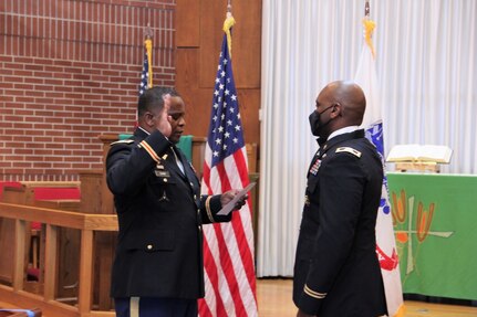Then-Lt. Col. Clayton Carr, right, recites the officer’s oath during his promotion to colonel in October 2020. Administering the oath is Carr’s brother, Col. Robert Carr. (Katie Ellis-Warfield)