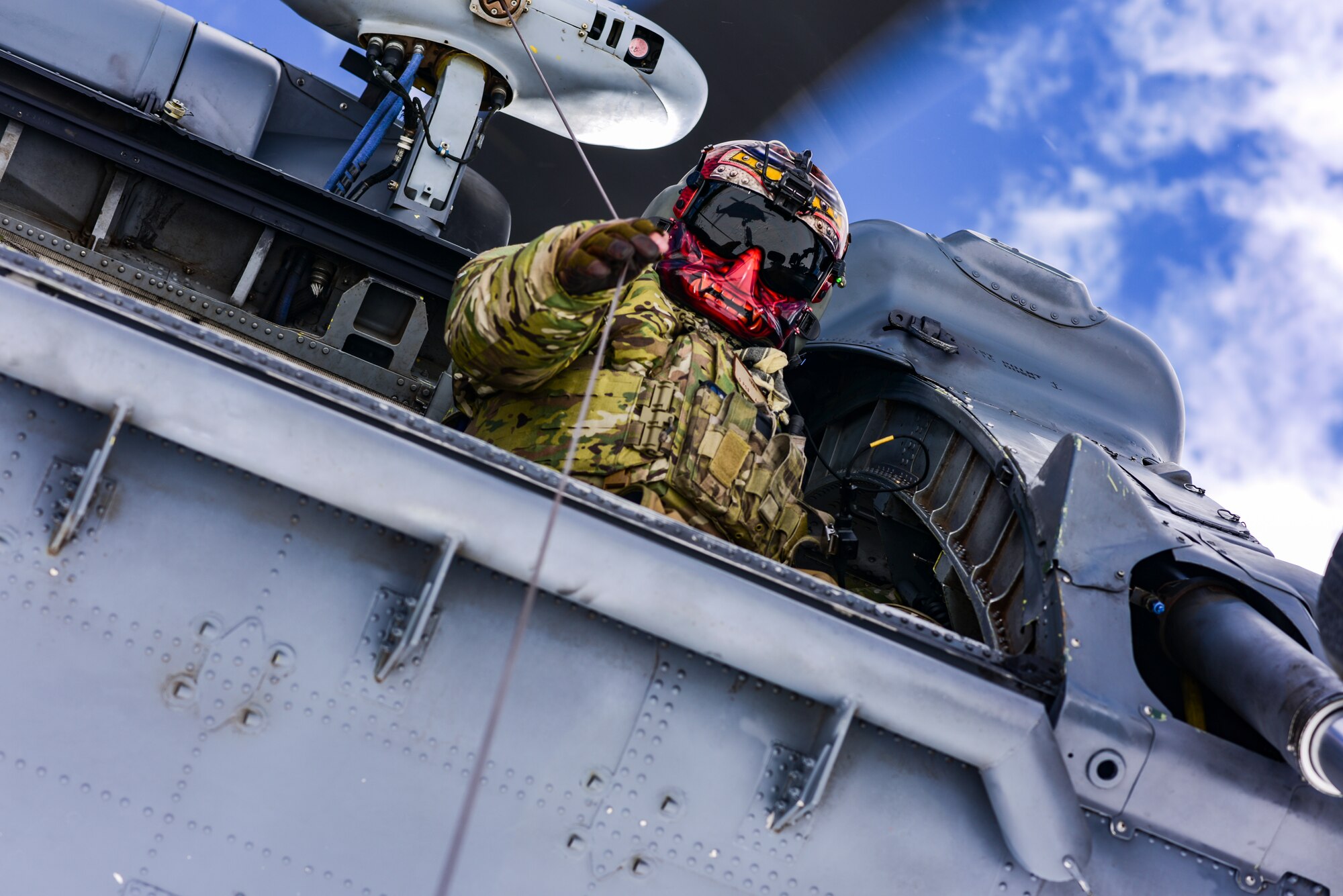 a photo of an Airman hoisting someone into a helicopter