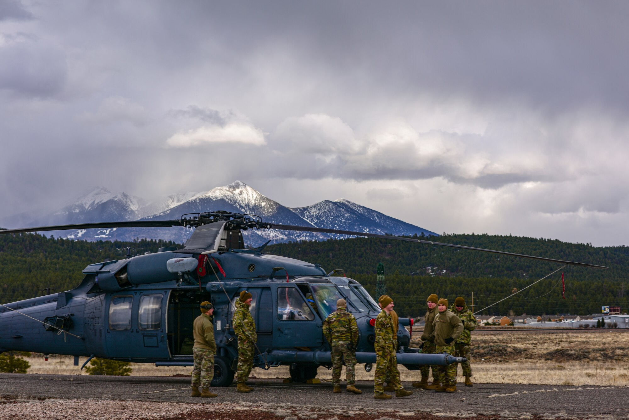 a photo of Airmen working on a helicopter