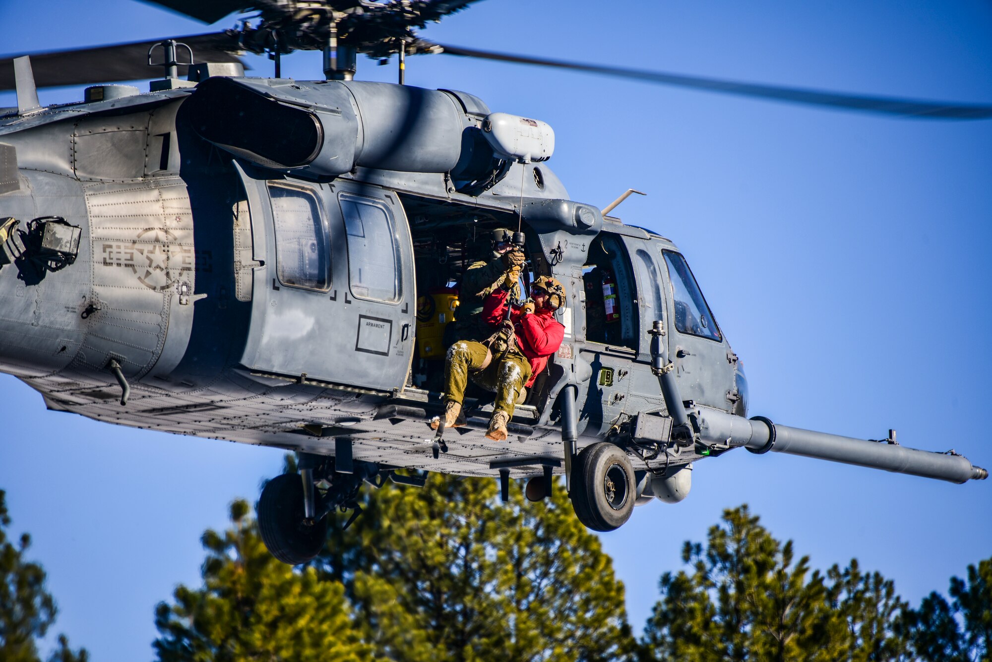 a photo of an Airman getting hoisted into a helicopter
