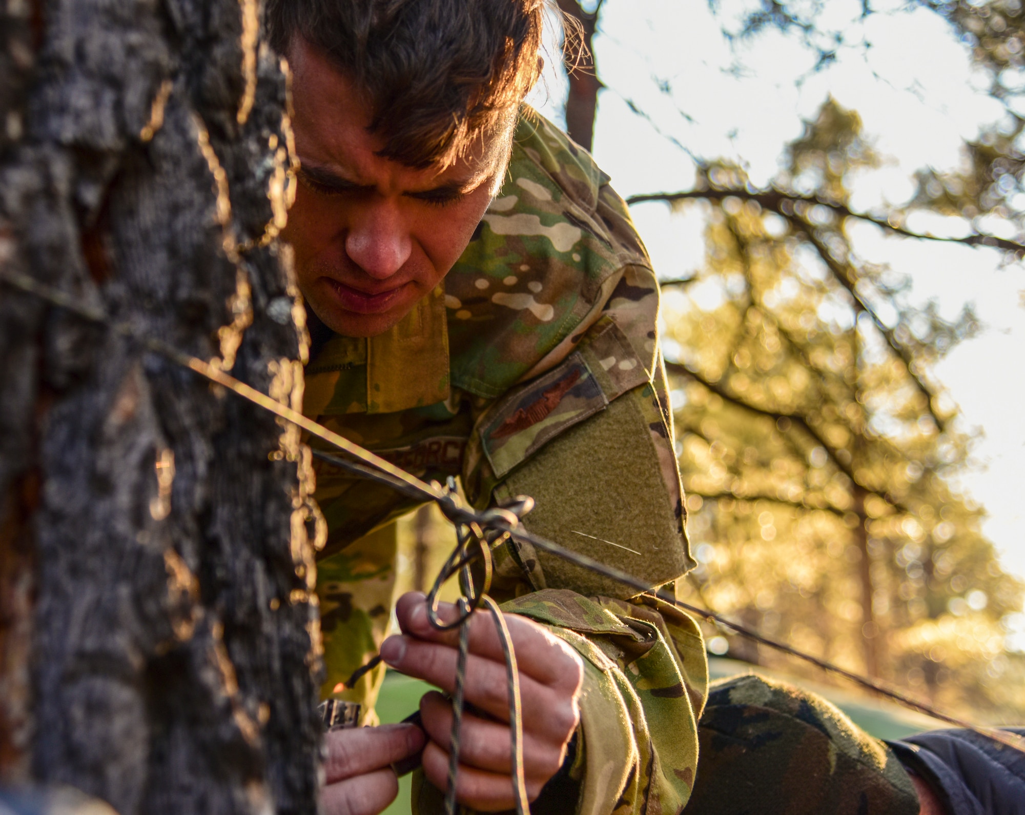 a photo of an Airman setting up a shelter