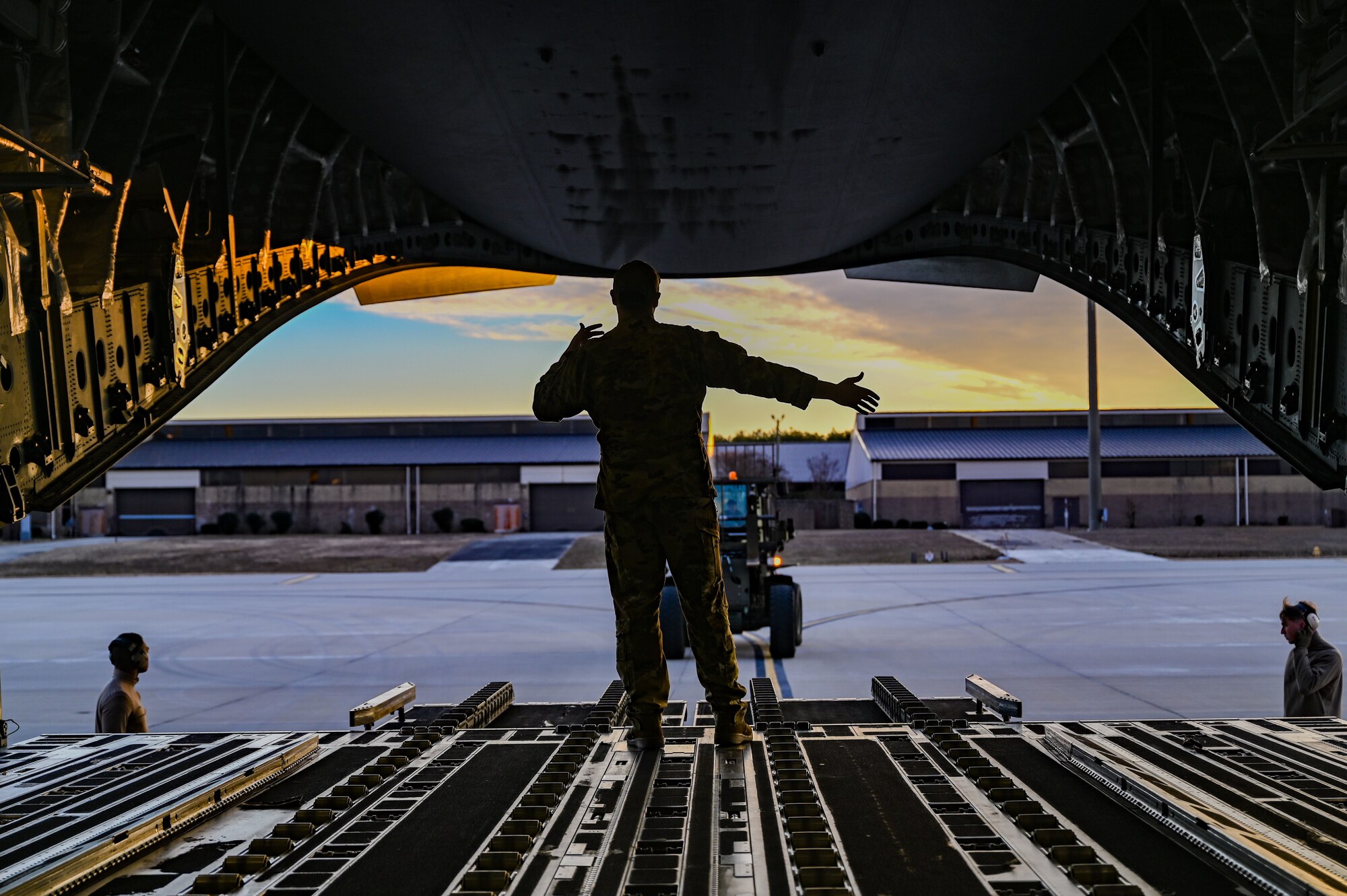 An Airman directs loading of equipment onto a C-17 Globemaster III.