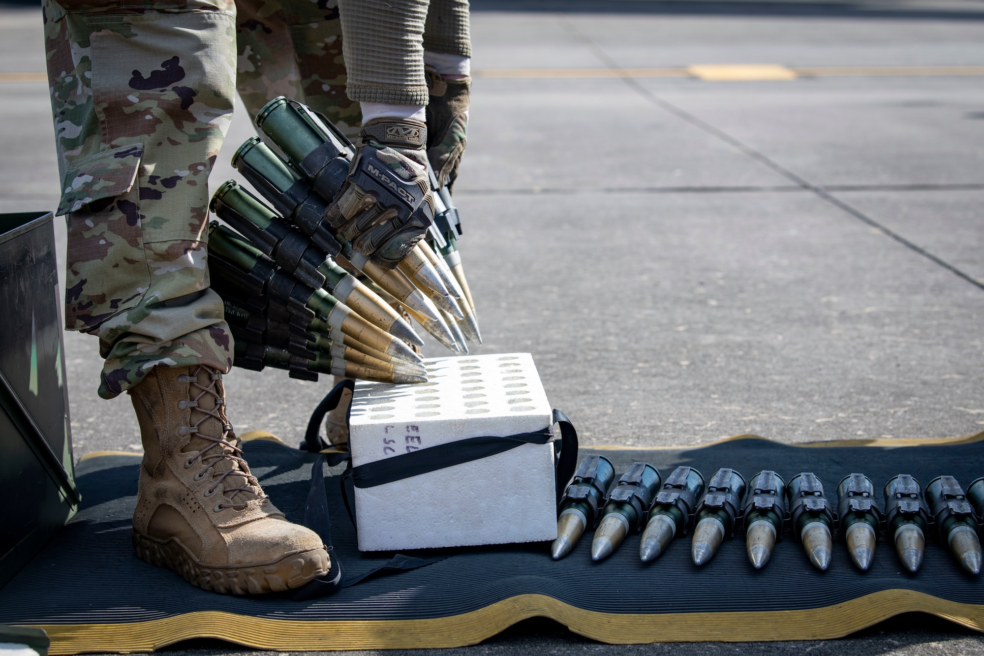 U.S. Air Force Senior Airman David Robinson, a 73rd Aircraft Maintenance Unit load crew member, inspects 30mm ammunition as part of the 2022 Weapons Load Crew of the Year Competition, Jan. 31, 2022, at Hurlburt Field, Florida.