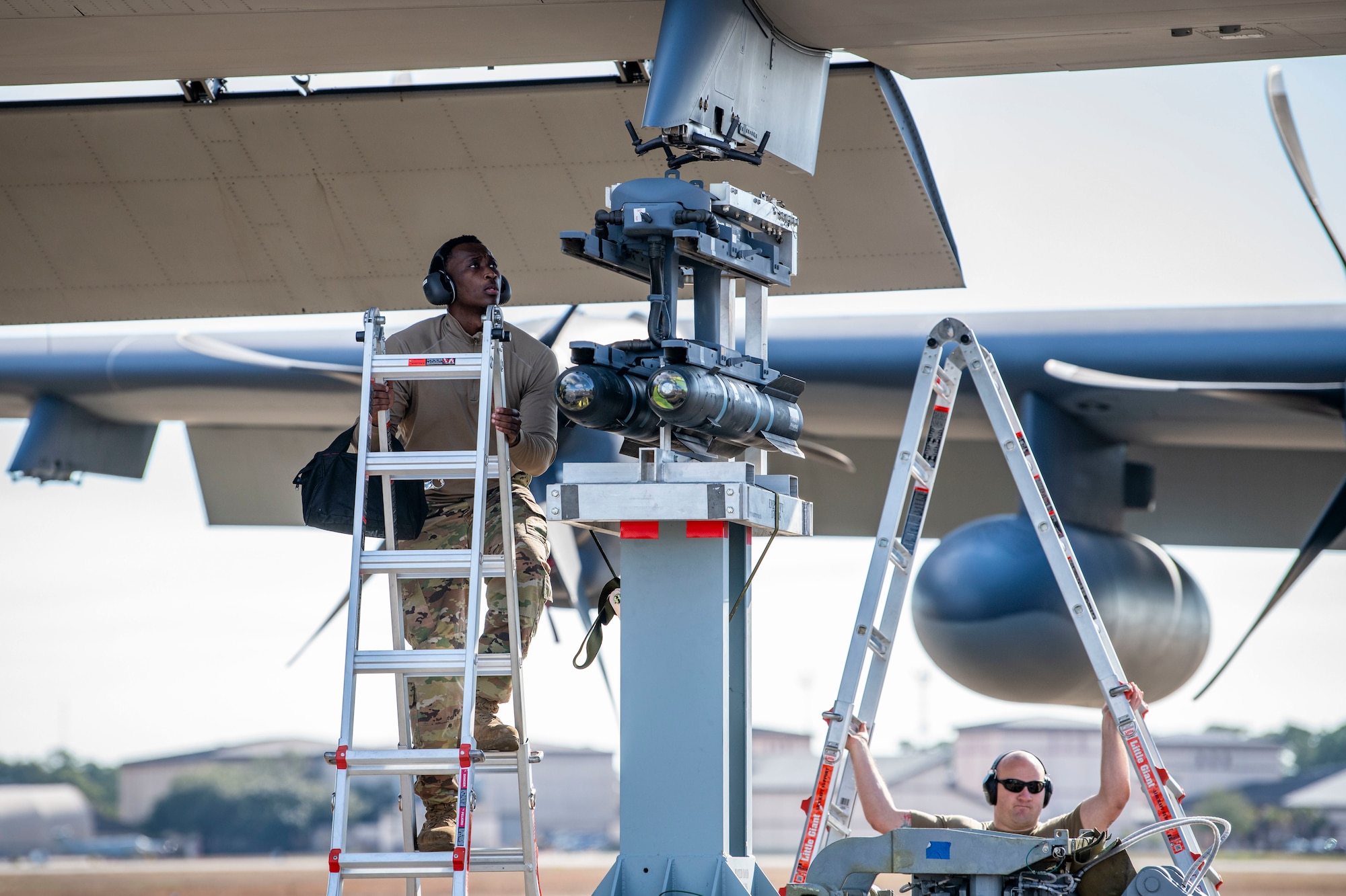 U.S. Air Force Senior Airman Jordan Jones, a 4th Aircraft Maintenance Unit load crew member, helps load two AGM-114 Hellfire missiles onto an AC-130J Ghostrider gunship during the 2022 Weapons Load Crew of the Year Competition, Jan. 31, 2022, at Hurlburt Field, Florida.