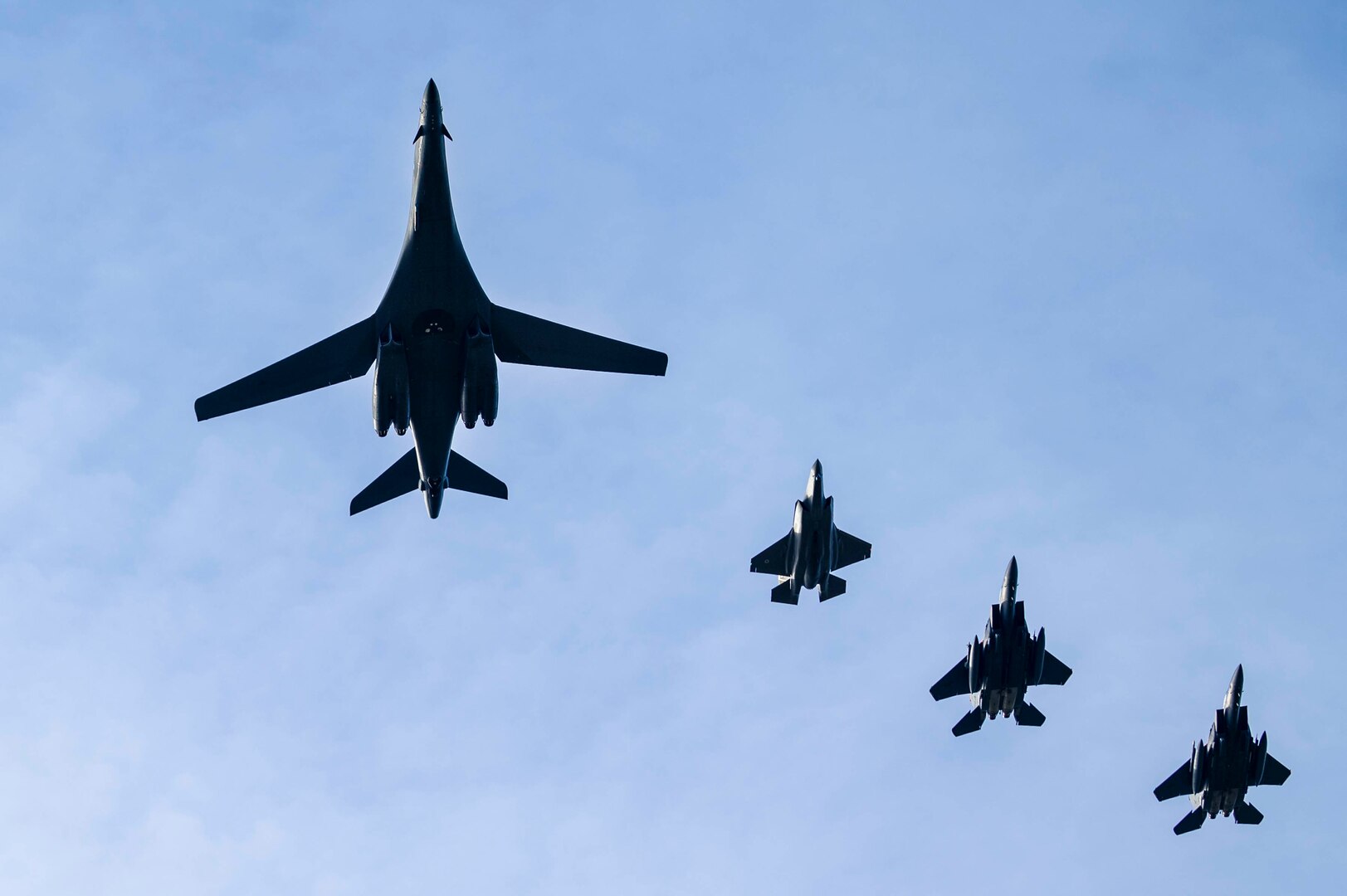 A U.S. Air Force B-1B Lancer assigned to 28th Bomb Wing and two F-15E Strike Eagles assigned to the 492nd and 494th Fighter Squadrons as well as a Royal Air Force F-35B Lightning conduct a flyover at Royal Air Force Lakenheath, England, Feb. 1, 2022.