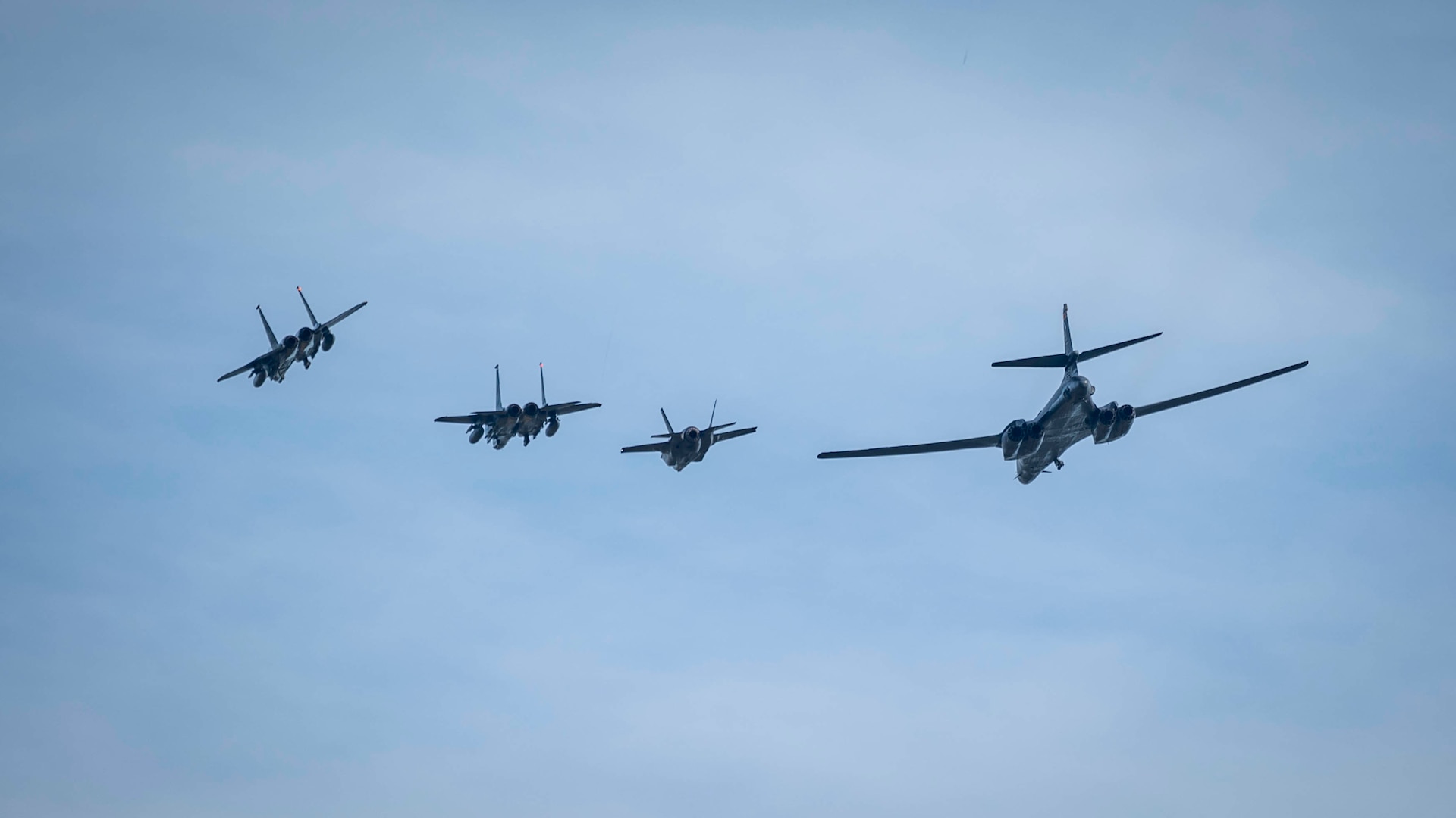 A U.S. Air Force B-1B Lancer assigned to 28th Bomb Wing and two F-15E Strike Eagles assigned to the 492nd and 494th Fighter Squadrons as well as a Royal Air Force F-35B Lightning conduct a flyover at Royal Air Force Lakenheath, England, Feb. 1, 2022.