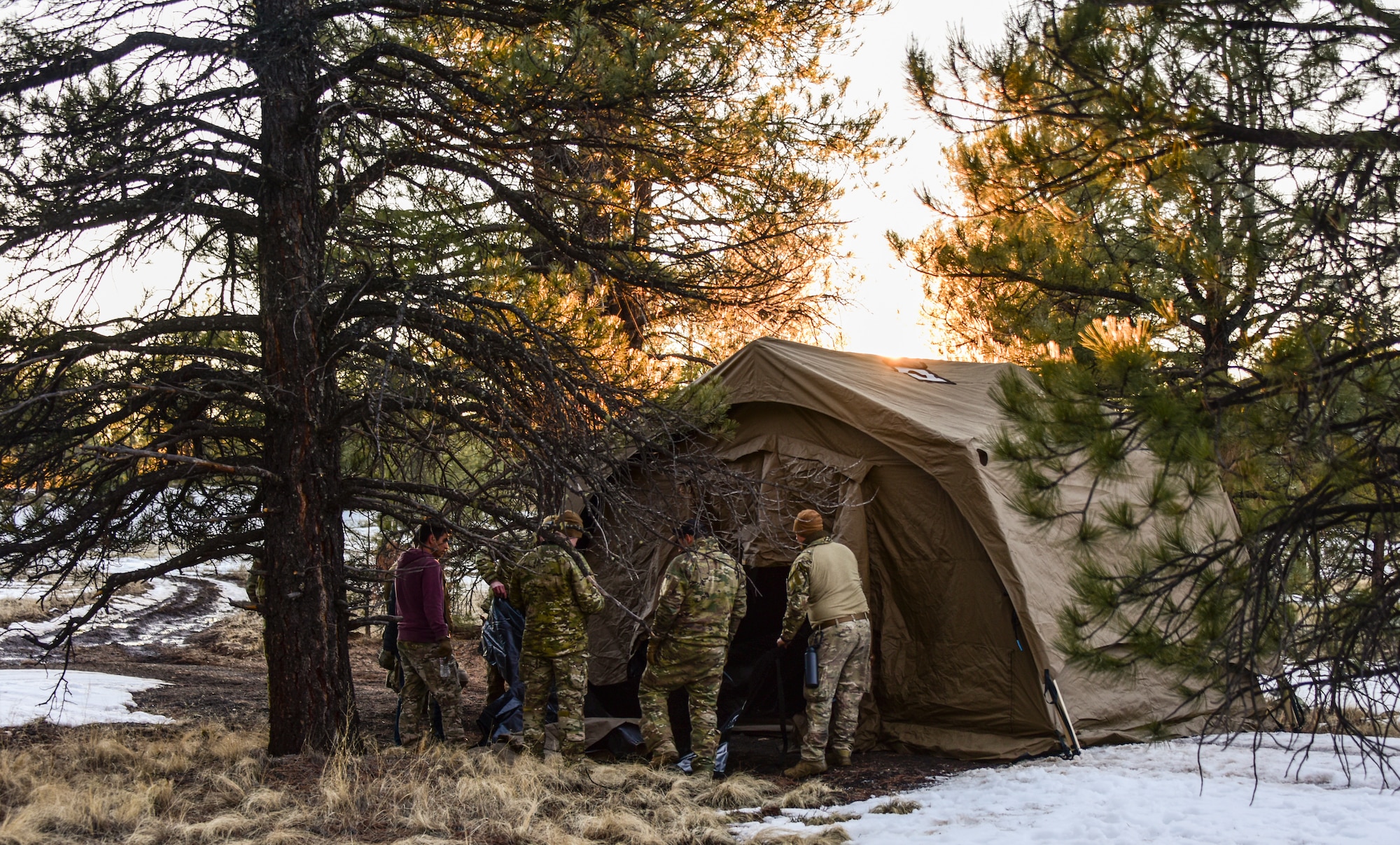 a photo of Airmen setting up a tent