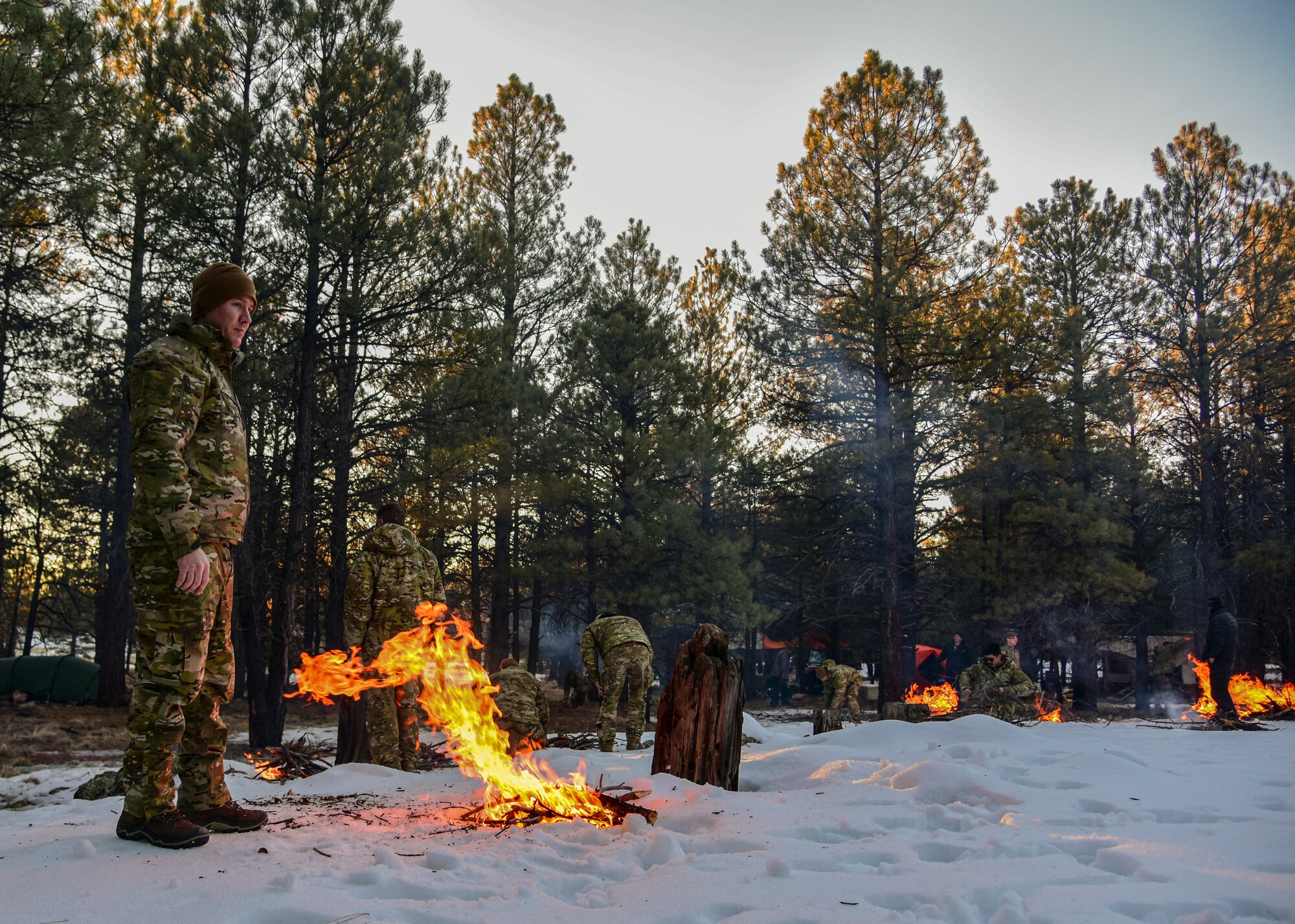 a photo of an Airman building a fire