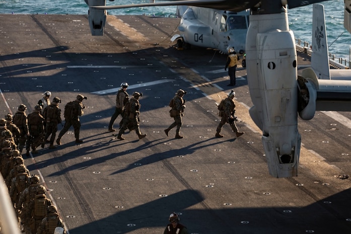 U.S. Marines with 2nd Battalion, 6th Marine Regiment, board and MV-22 Osprey during Composite Training Unit Exercise (COMPTUEX), aboard amphibious assault ship USS Kearsarge (LHD 3), Jan. 27, 2022. COMPTUEX is the last at-sea period of the ARG/MEU Predeployment Training Program. COMPTUEX is the final certifying step before the ARG/MEU team demonstrate its readiness to deploy. (U.S. Marine Corps photo by Cpl. Yvonna Guyette)