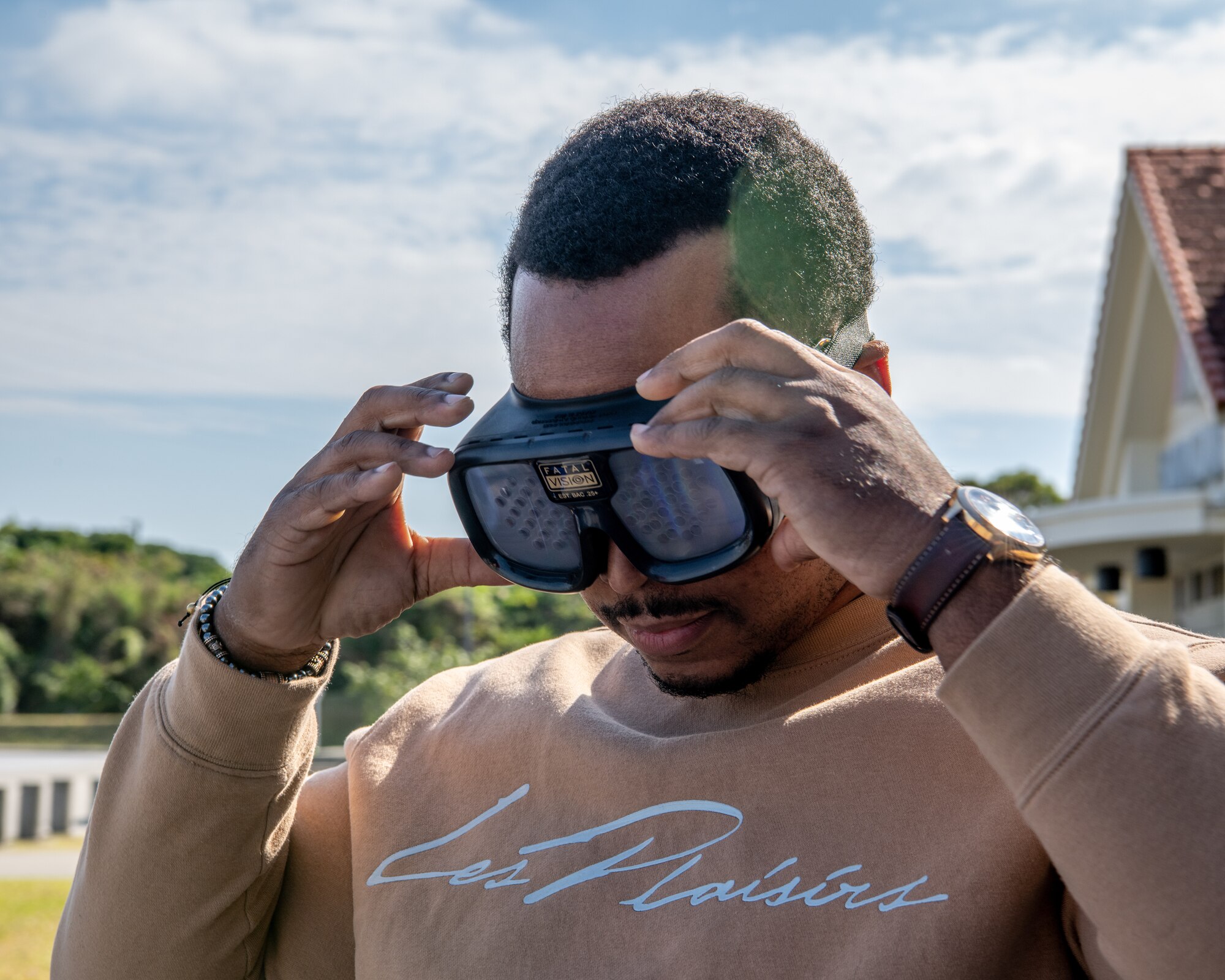 A man tries on vision impairment goggles.