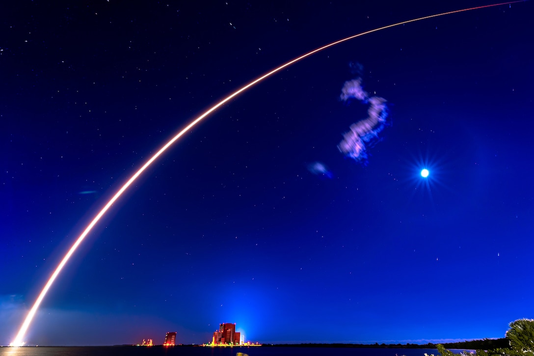 A rocket launches at night.
