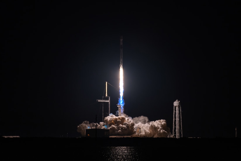 A rocket launches at night.