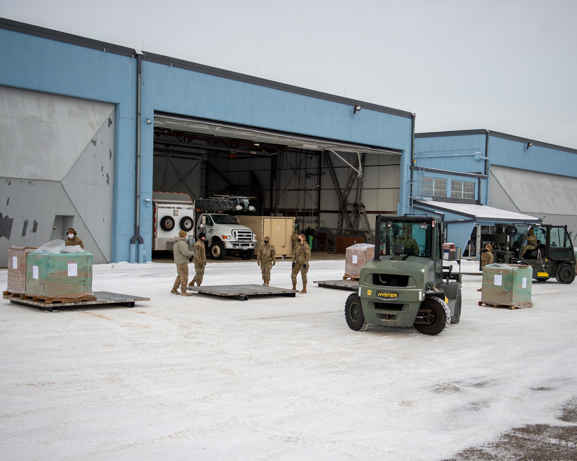 U.S. Air Force Airmen with the 133rd Air Transportation Function move an estimated 11,300 pounds of medical equipment onto eight pallets during cargo buildup in St. Paul, Minn., Jan. 08, 2022.