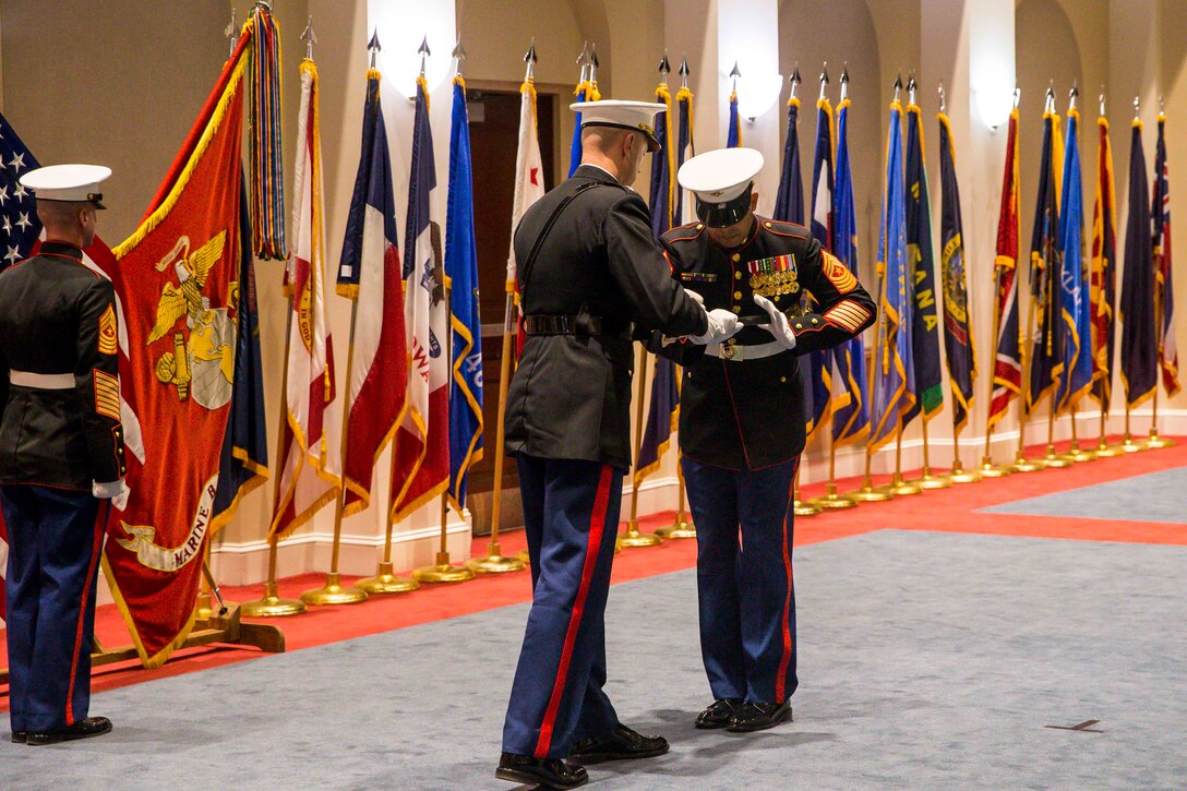 Colonel Teague A. Pastel, commanding officer, Marine Barracks Washington, passes the noncommissioned officer sword to Sgt. Maj. Jesse J. Dorsey, incoming sergeant major, MBW, during a relief and appointment ceremony at MBW, Jan. 31, 2022.