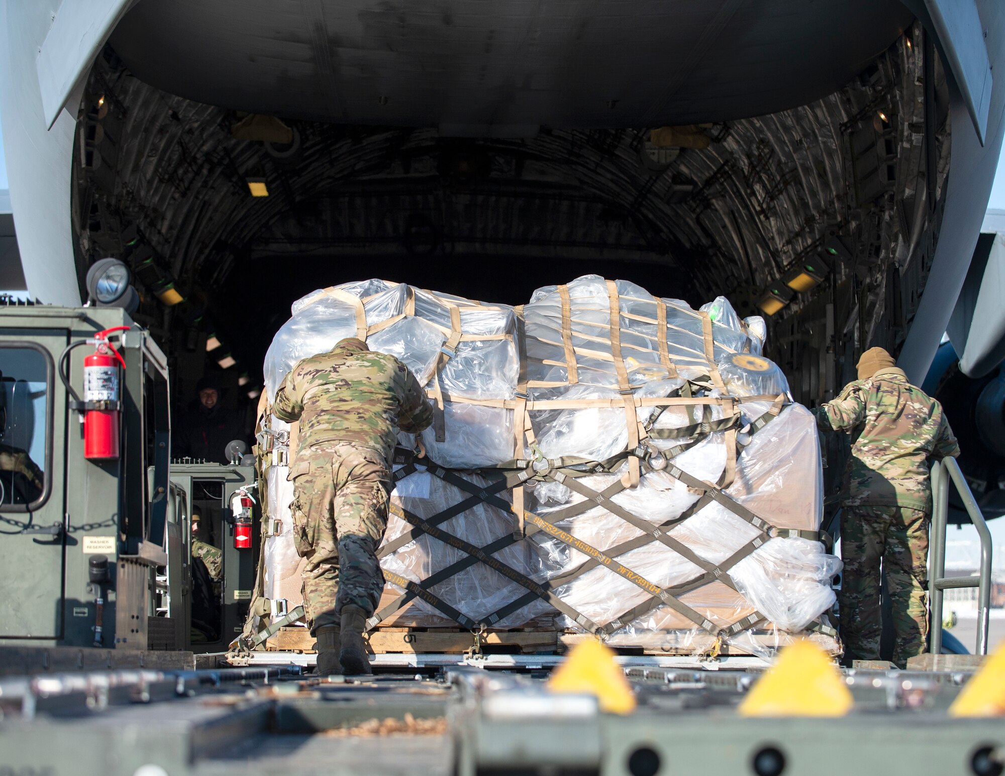 U.S. Air Force Airmen from the 133rd Air Transportation Function, load an estimated 11,300 pounds of medical supplies onto a C-17 Globemaster in St. Paul, Minn., Jan. 20, 2022.