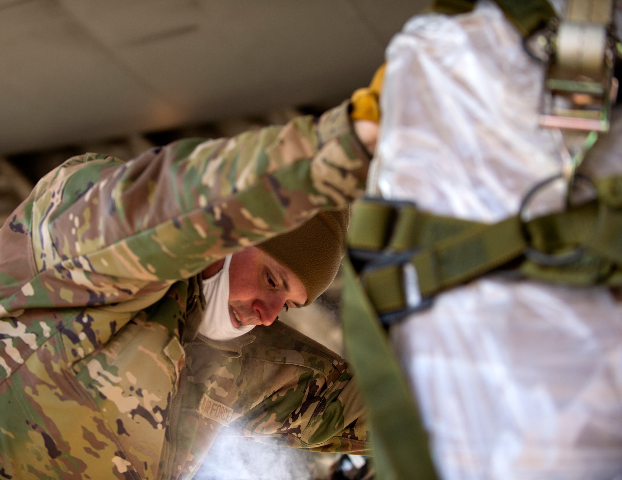 U.S. Air Force Master Sgt. Jesse McLean, 133rd Air Transportation Function, pushes a pallet onto a C-17 Globemaster in St. Paul, Minn., Jan. 20, 2022.