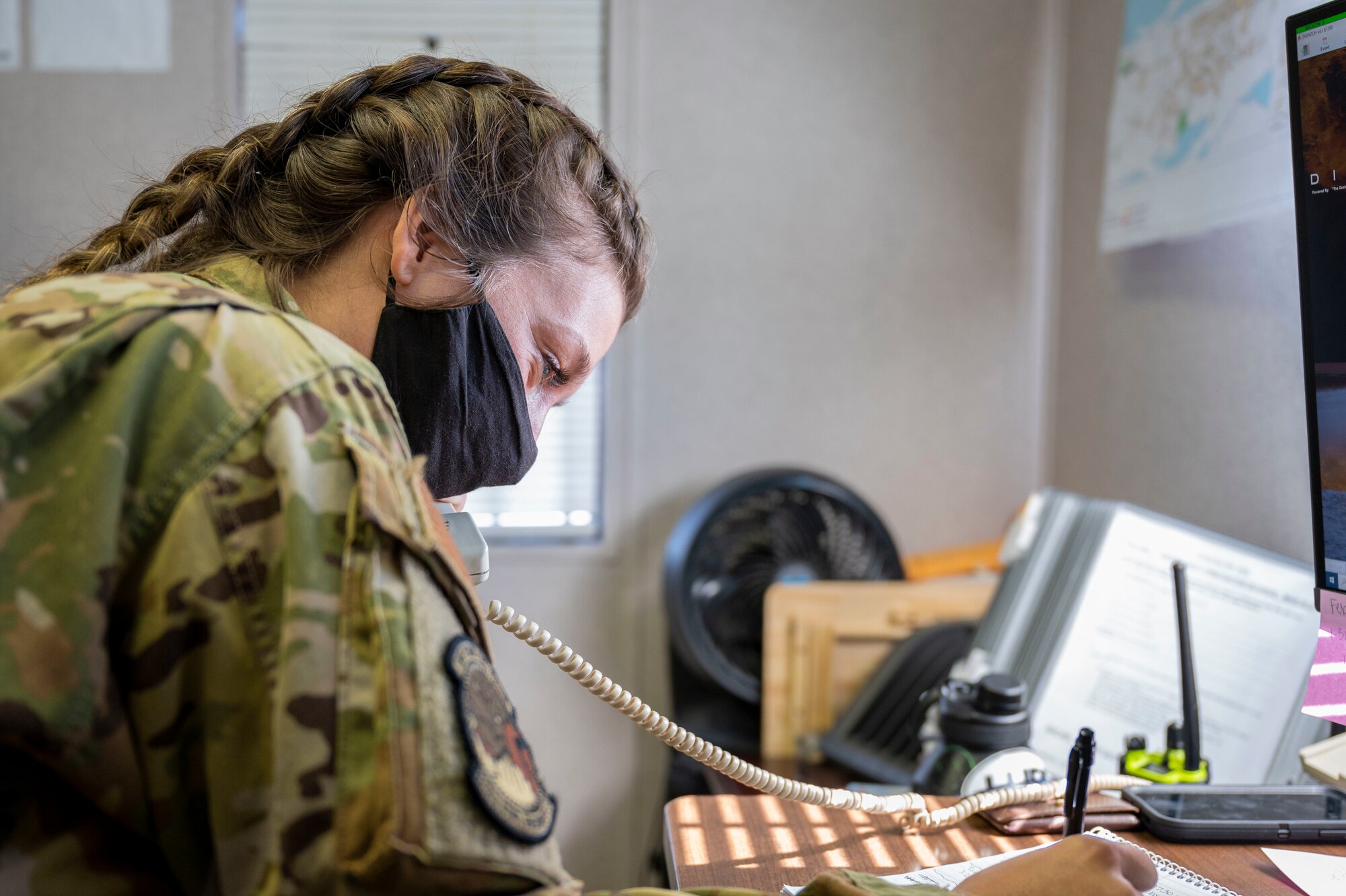 Woman writing down information while on the phone