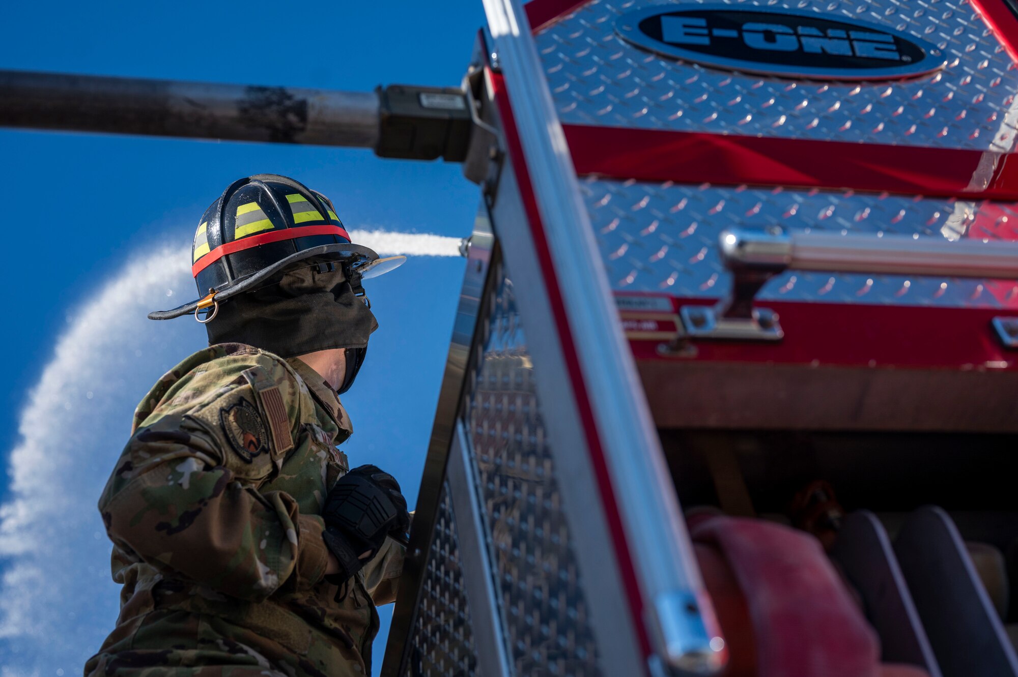 Fireman sprays water using a deck gun