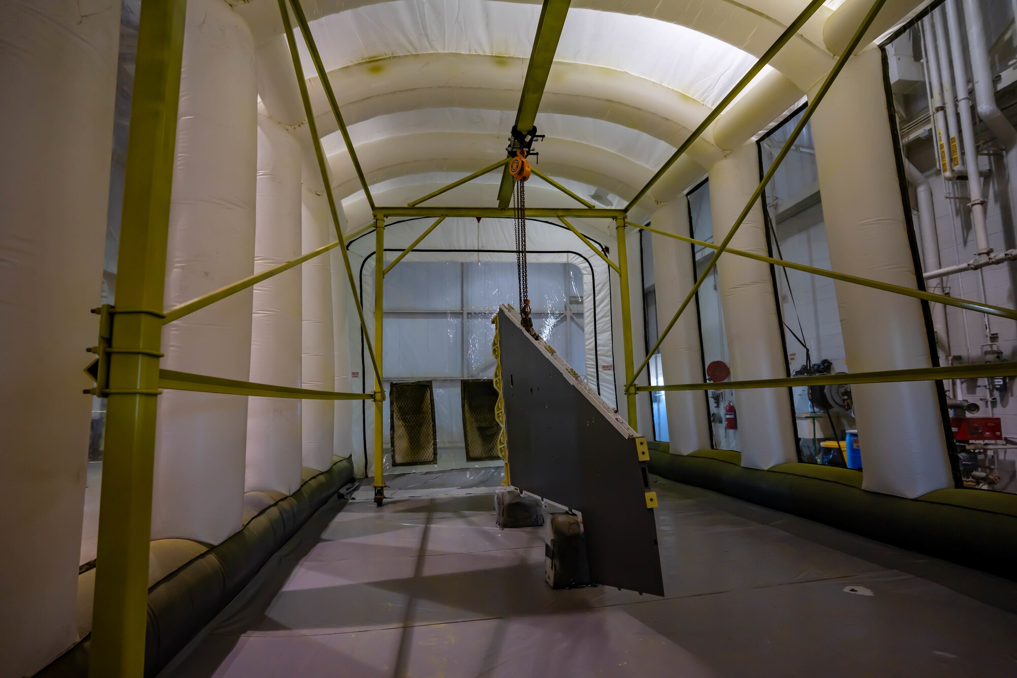 F-16C wing dries after being painted in a portable paint booth assembled by the 114th Structural Repair shop. The portable paint booth has saved the wing money and time for structural repair Airmen. (U.S. Air National Guard photo by Master Sgt. Duane Duimstra)
