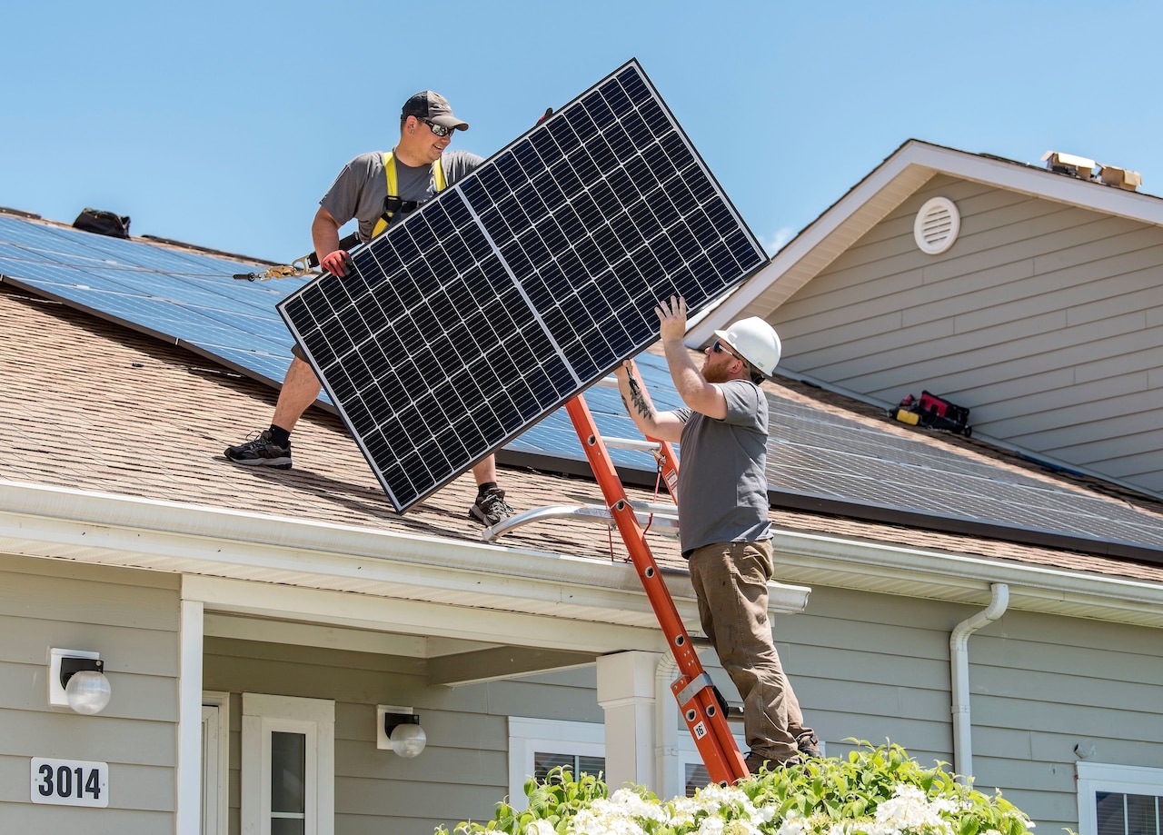 Men handle solar panel
