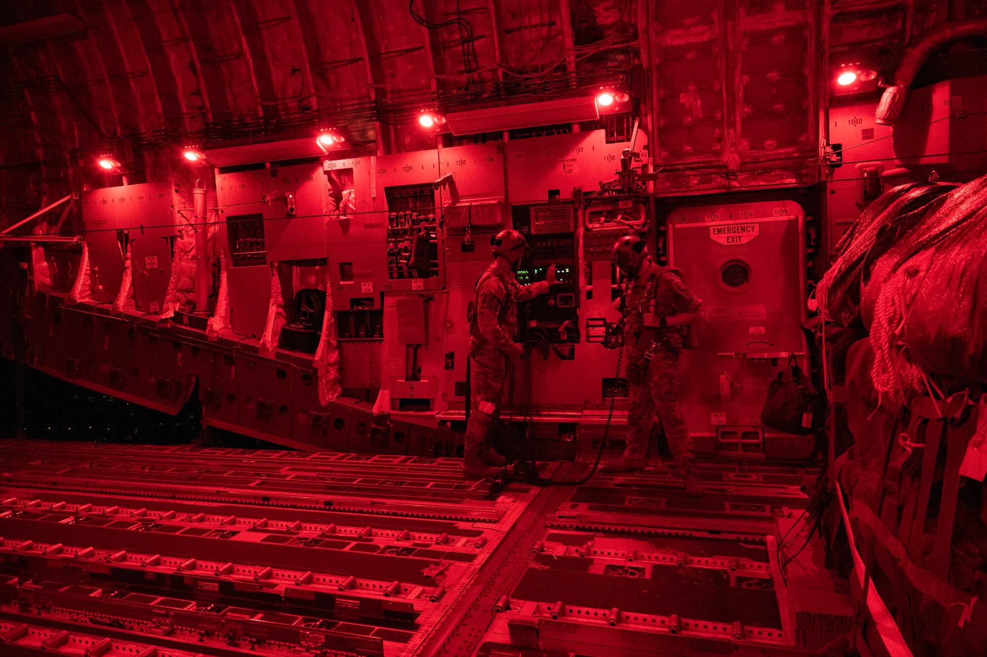 Aircrew work inside a C-17 Globemaster.