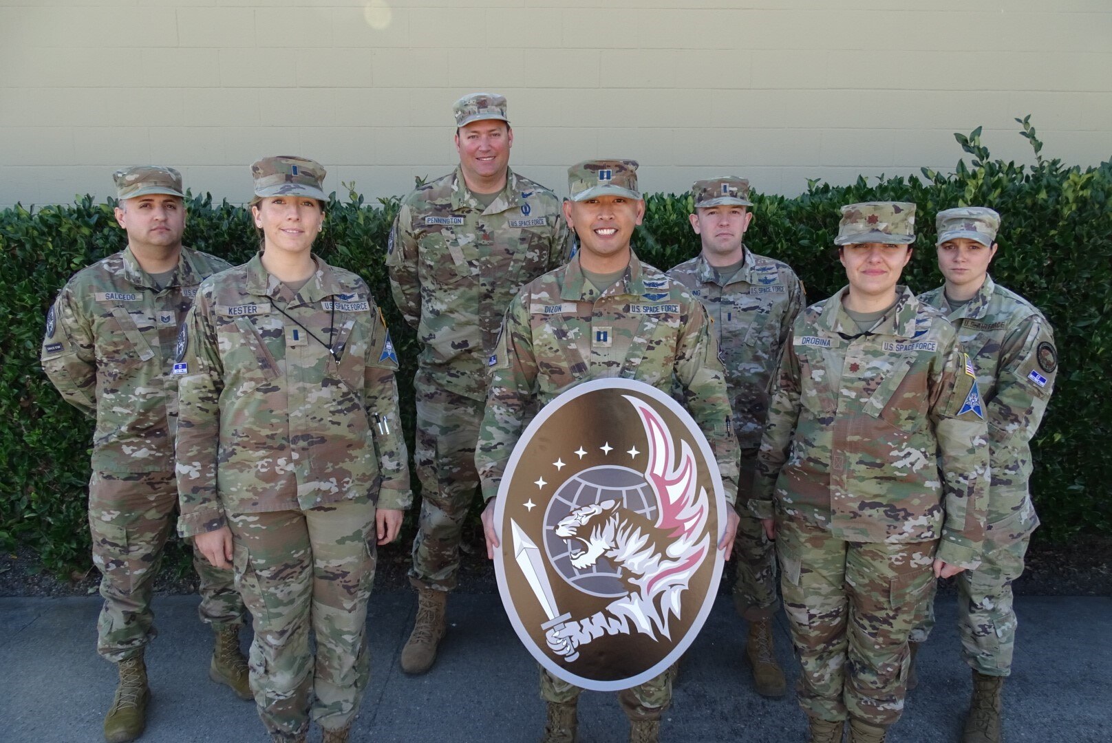 Group of 55 Combat Training Squadron guardians with unit emblem.