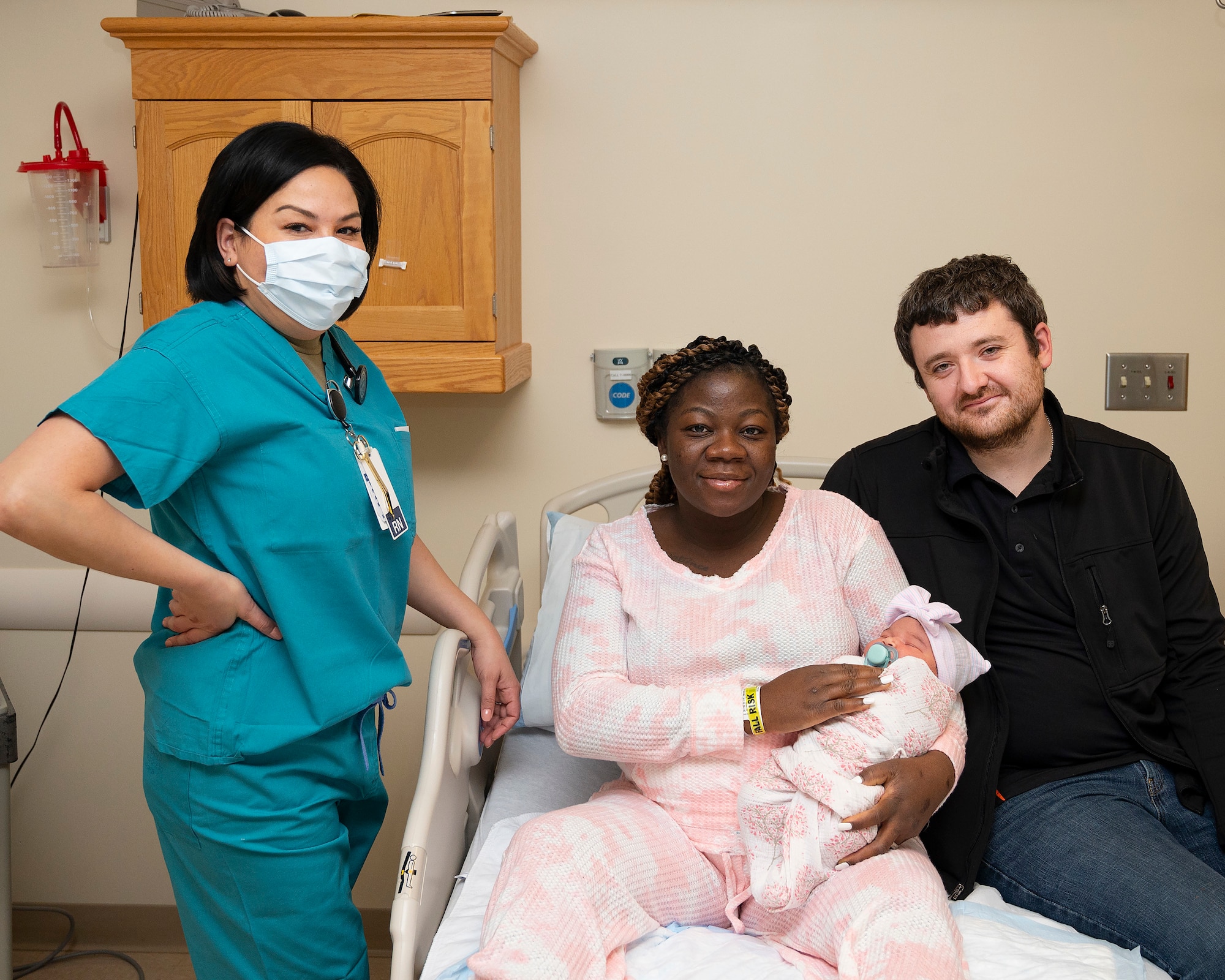 Capt. Dahlia Garcia (left), 88th Inpatient Operations Squadron charge nurse, poses with Patience Mantor, Army Spc. Cody Wallace and their 1-day-old baby, Kalea, on Jan. 5, 2022, in the Wright-Patterson Medical Center Labor and Delivery Ward. Kalea was the base hospital’s first baby of the year. (U.S. Air Force photo by R.J. Oriez)