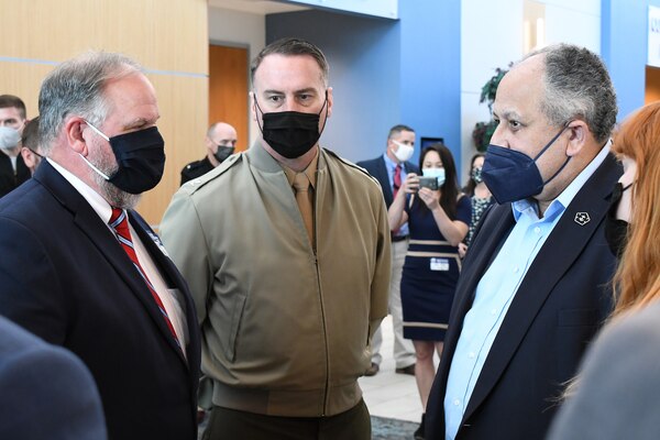 Secretary of the Navy Carlos Del Toro speaks with Fleet Readiness Center East Commanding Officer Col. Thomas Atkinson and Eastern North Carolina Tech Bridge Director Jeff Nelson.