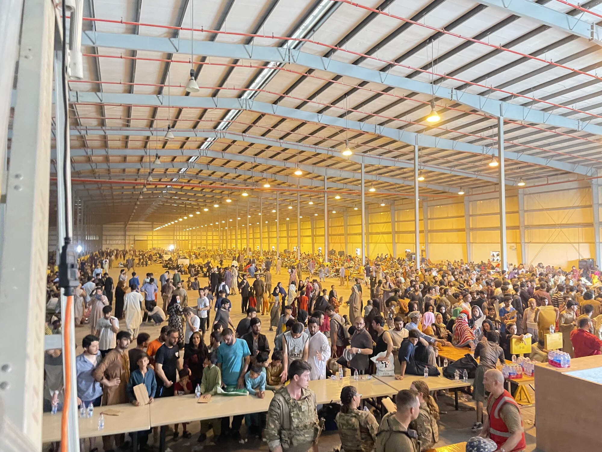 Refugees fill a hangar