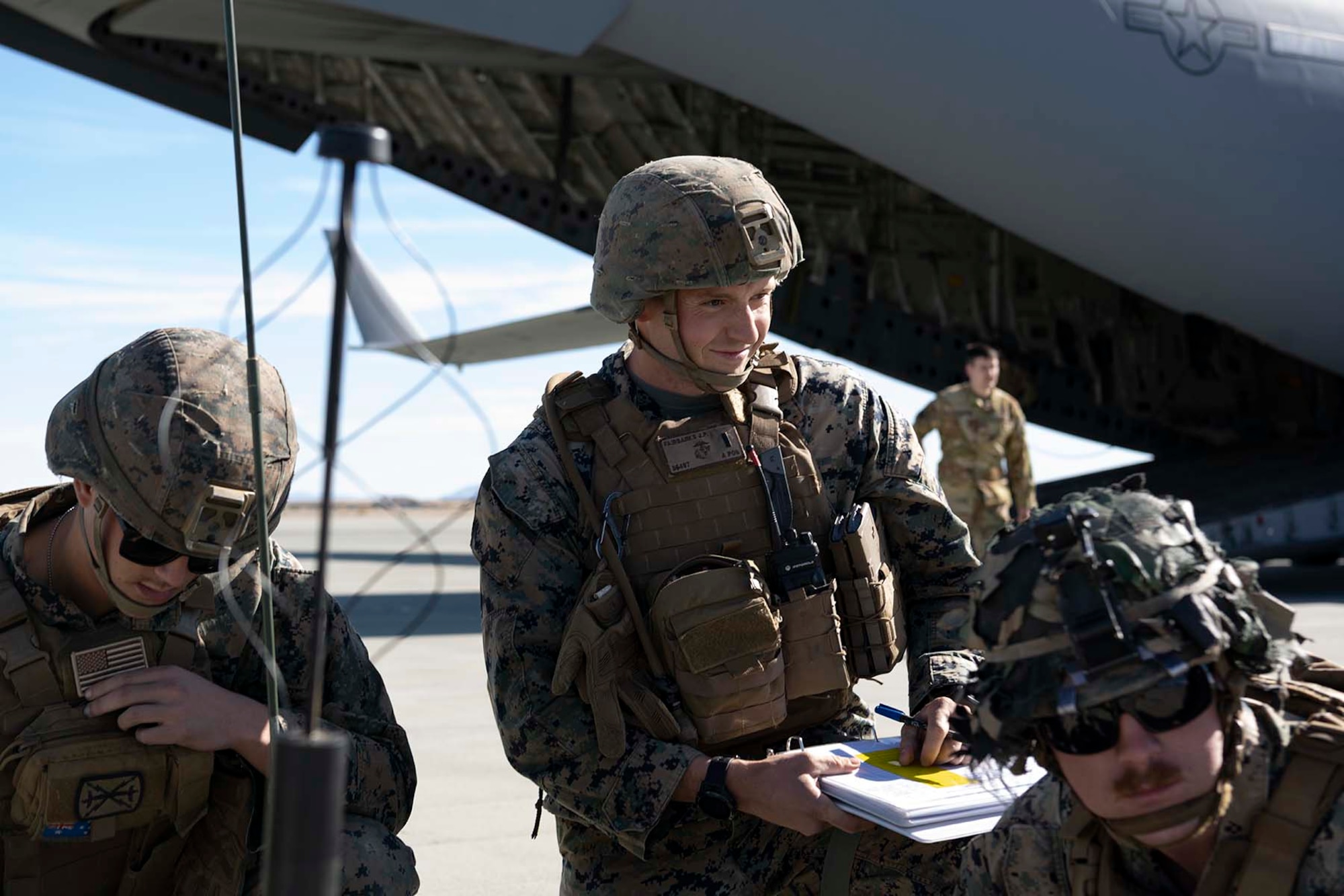 marines gather beside an aircraft