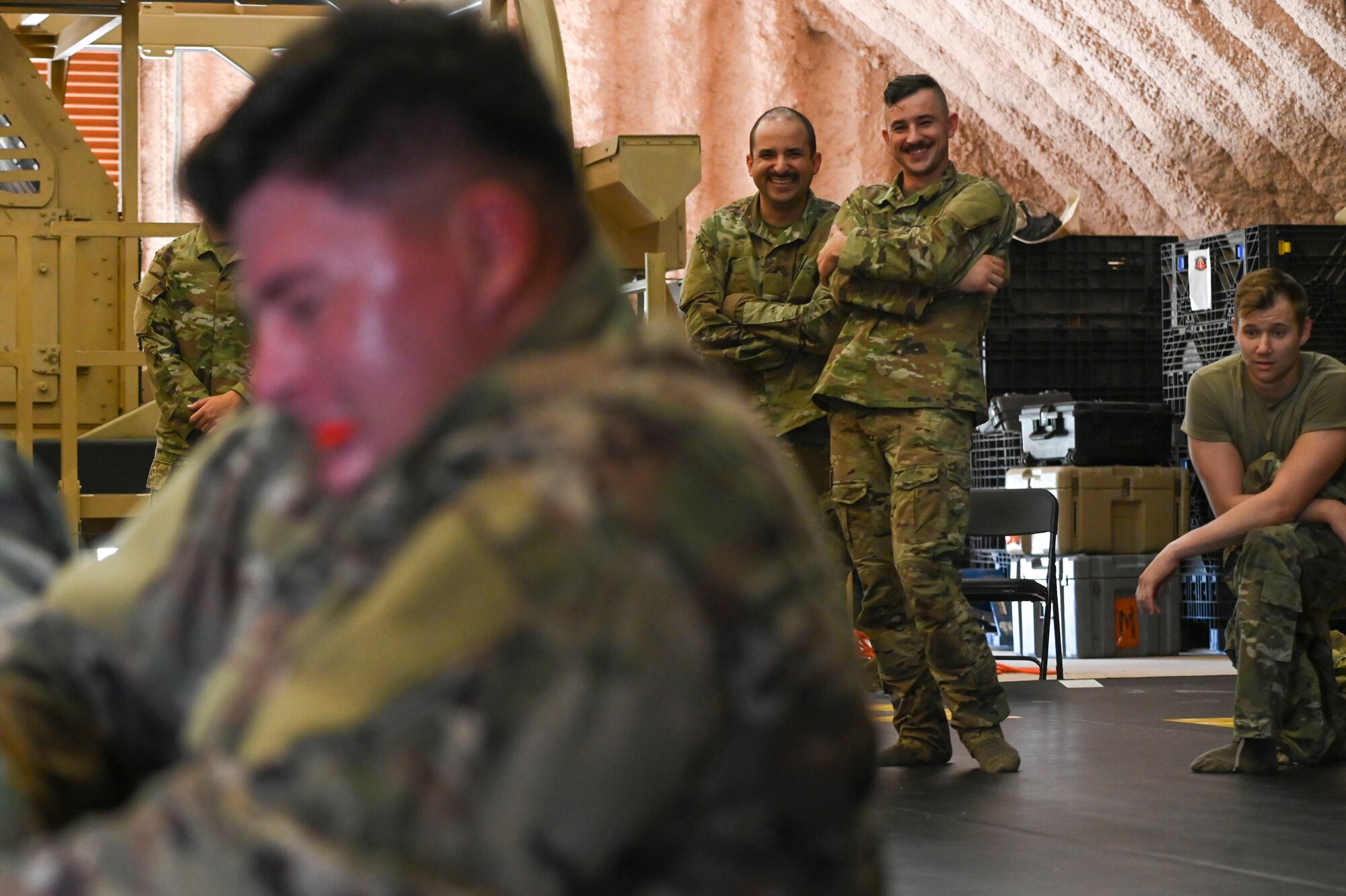 A group of Airmen laughing at people wrestling