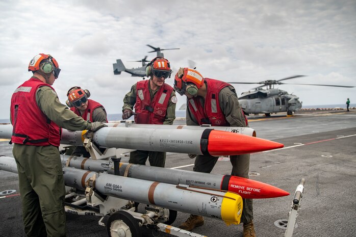 U.S. Marines assigned to Marine Attack Squadron 214, 11th Marine Expeditionary Unit, prepare to load ordnance while aboard the Wasp-class amphibious assault ship USS Essex (LHD 2) in support of Exercise Noble Fusion, Feb. 3, 2022. Noble Fusion demonstrates that Navy and Marine Corps forward-deployed, stand-in naval expeditionary forces can operate as a Marine Expeditionary Unit/Amphibious Ready Group team at sea, along with a carrier strike group, in order to conduct lethal sea-denial operations, seize key maritime terrain, guarantee freedom of movement, and create advantage for U.S., partner, and allied forces.