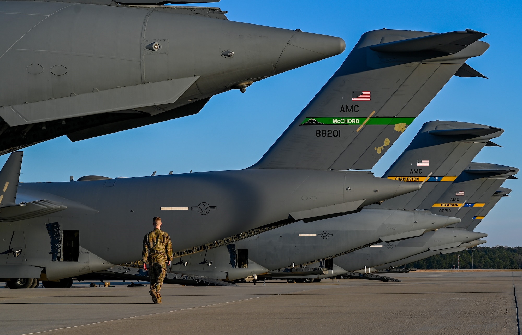 Airman walks beside C-17 Globemaster III aircraft.
