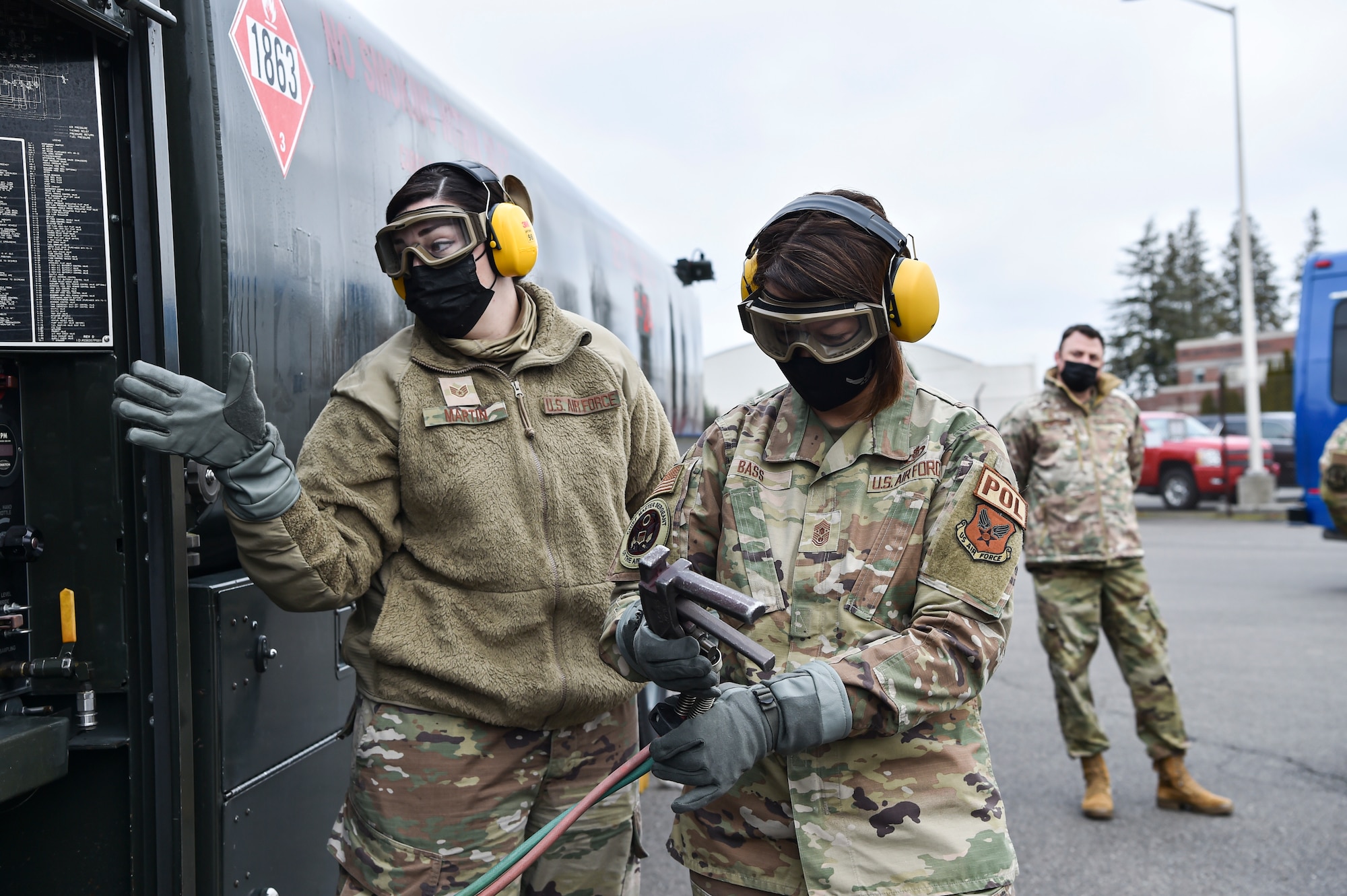 Chief Master Sergeant of the Air Force JoAnne S. Bass learns how to conduct specialized fueling operations with assistance from Staff Sgt. Kristin Martin, 627th Logistics Readiness Squadron fuels distribution supervisor, at Joint Base Lewis-McChord, Washington, Feb. 1, 2022. During her visit, Bass toured several McChord units and recognized Airmen for excellent performance. (U.S. Air Force photo by Staff Sgt. Tryphena Mayhugh)