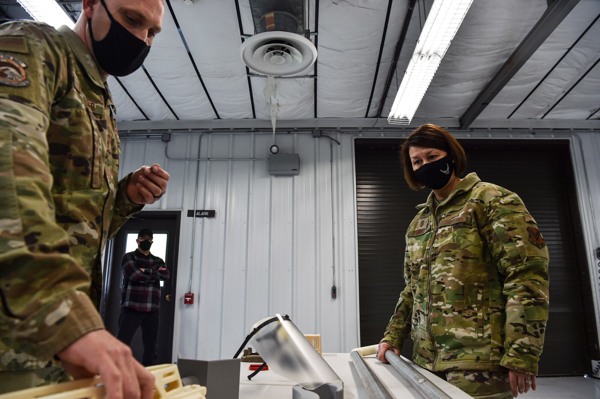 Chief Master Sergeant of the Air Force JoAnne S. Bass learns about multiple pieces of equipment that can be 3-D printed on location by Senior Master Sgt. Jayson Householder, 446th Maintenance Squadron, during her visit to McChord Field at Joint Base Lewis-McChord, Washington, Feb. 1, 2022. Bass toured several McChord units and recognized Airmen for excellent performance. (U.S. Air Force photo by Staff Sgt. Tryphena Mayhugh)