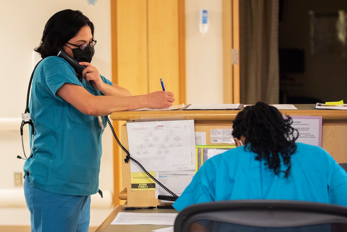Capt. Dahlia Garcia, 88th Inpatient Operations Squadron charge nurse, takes notes as she talks to an expectant mother on the phone Dec. 16, 2021, during her overnight shift with Wright-Patterson Medical Center’s Labor and Delivery Ward. In her role, Garcia is a resource for expectant mothers throughout the night. (U.S. Air Force photo by R.J. Oriez)