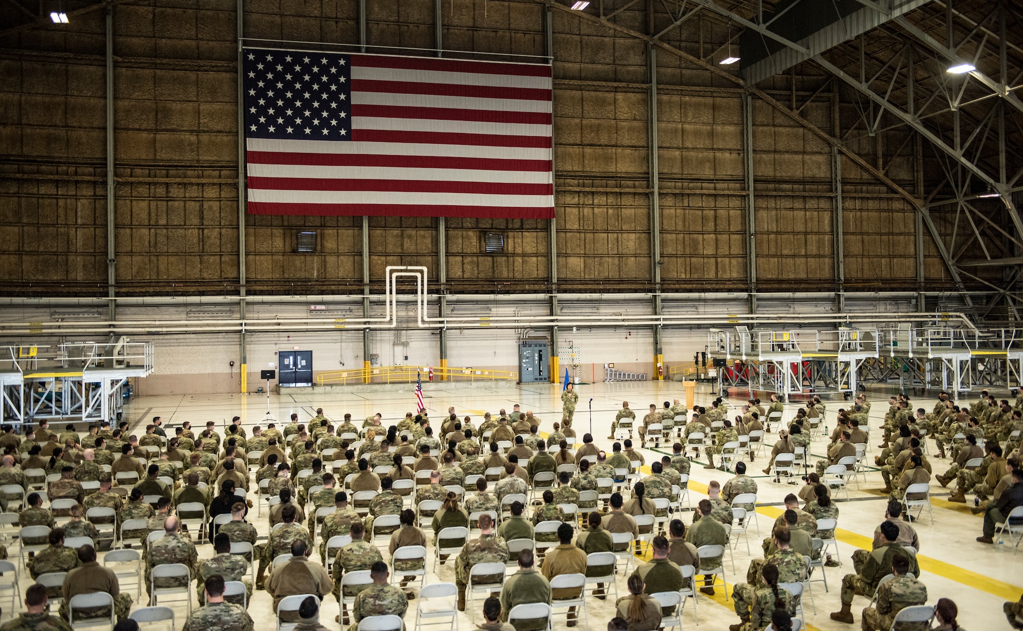 Chief Master Sergeant of the Air Force JoAnne S. Bass speaks to Team McChord Airmen during an all-call while visiting McChord Field at Joint Base Lewis-McChord, Washington, Feb. 2, 2022. During her visit, Bass toured several McChord units and recognized Airmen for excellent performance. (U.S. Air Force photo by Tech. Sgt. Benjamin Sutton)