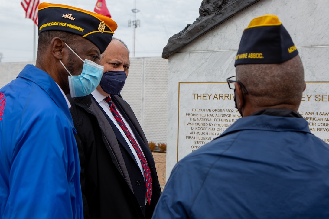 Secretary of the Navy Carlos Del Toro speaks with retired U.S. Marine Corps Chief Warrant Officer 5 Houston Shinal, monument director, and retired U.S. Marine Sgt. Maj. Johnny B. Young Jr., southern region vice president, both with the Montford Point Marines association, while touring Lejeune Memorial Gardens, Jacksonville, North Carolina, Jan. 28, 2022. The Secretary of the Navy toured MCB Camp Lejeune to visit II Marine Expeditionary Force and Lejeune Memorial Gardens and viewed the ongoing construction improvements, public private venture housing and hurricane recovery progress on the installation. (U.S. Marine Corps photo by Lance Cpl. Antonino Mazzamuto)