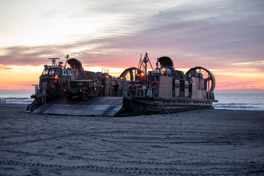 U.S. Marines assigned to the 22nd Marine Expeditionary Unit (MEU), load vehicles onto a landing craft, air cushion during an on loading of personnel and gear aboard Camp Lejeune, Jan. 15, 2022. The Kearsarge Amphibious Ready Group (ARG) and 22nd MEU are underway conducting Composite Training Unit Exercise (COMPTUEX). COMPTUEX is the final pre-deployment exercise that certifies the Kearsarge ARG and 22nd MEU’s ability to conduct military operations through joint planning, and execute challenging and realistic scenarios. (U.S. Marine Corps photo by Sgt. Mason Roy)