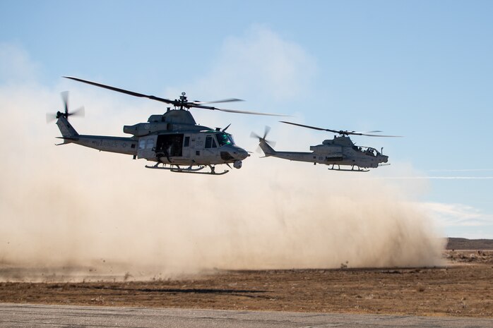 A UH-1Y Venom helicopter and an AH-1Z Viper helicopter assigned to Marine Light Attack Helicopter Squadron (HMLA) 269 take off at Lamar, Colorado, Nov. 6, 2021.